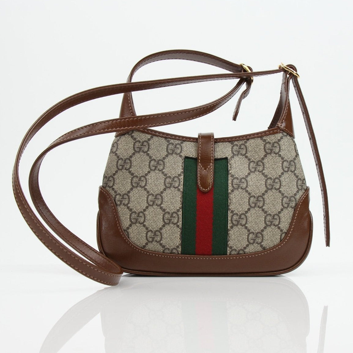 Gucci Jackie 1961 Mini handbag with beige canvas and brown leather trim, featuring gold-tone hardware and signature design elements.