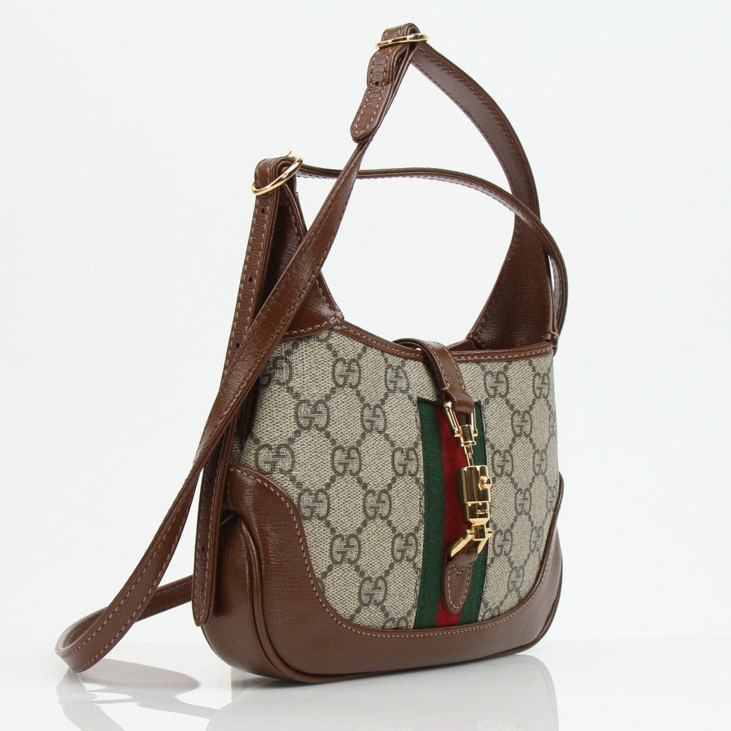 Gucci Jackie 1961 Mini handbag with beige and brown Gucci monogram canvas, leather trim, and top handle.