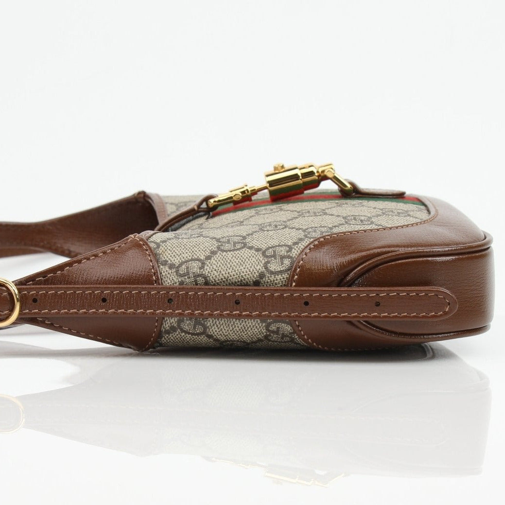 Gucci Jackie 1961 Mini handbag in leather with gold-tone hardware and signature design, featuring a top handle and structured silhouette.
