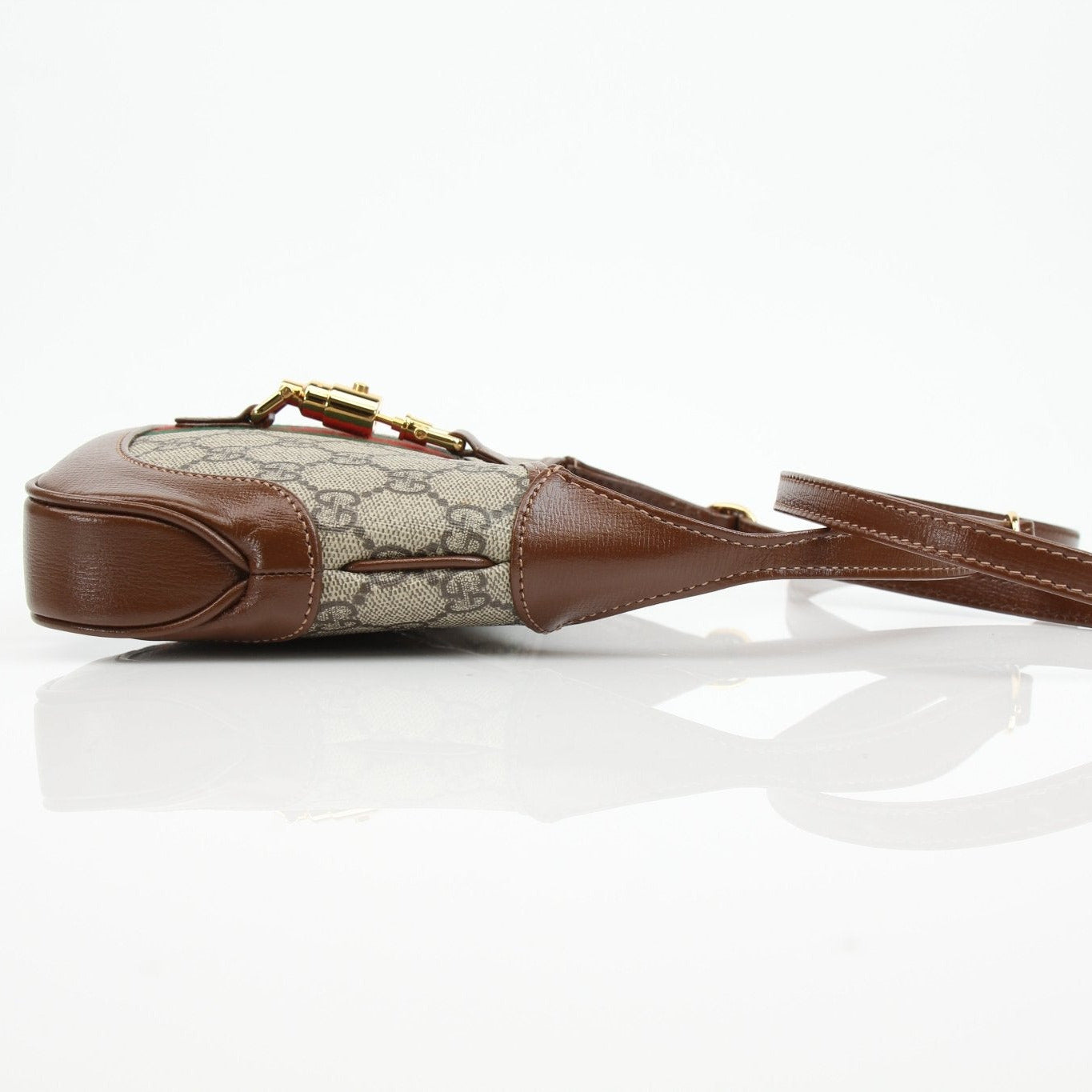 Gucci Jackie 1961 Mini Bag handbag with beige and brown leather, gold hardware, and signature GG logo detail.