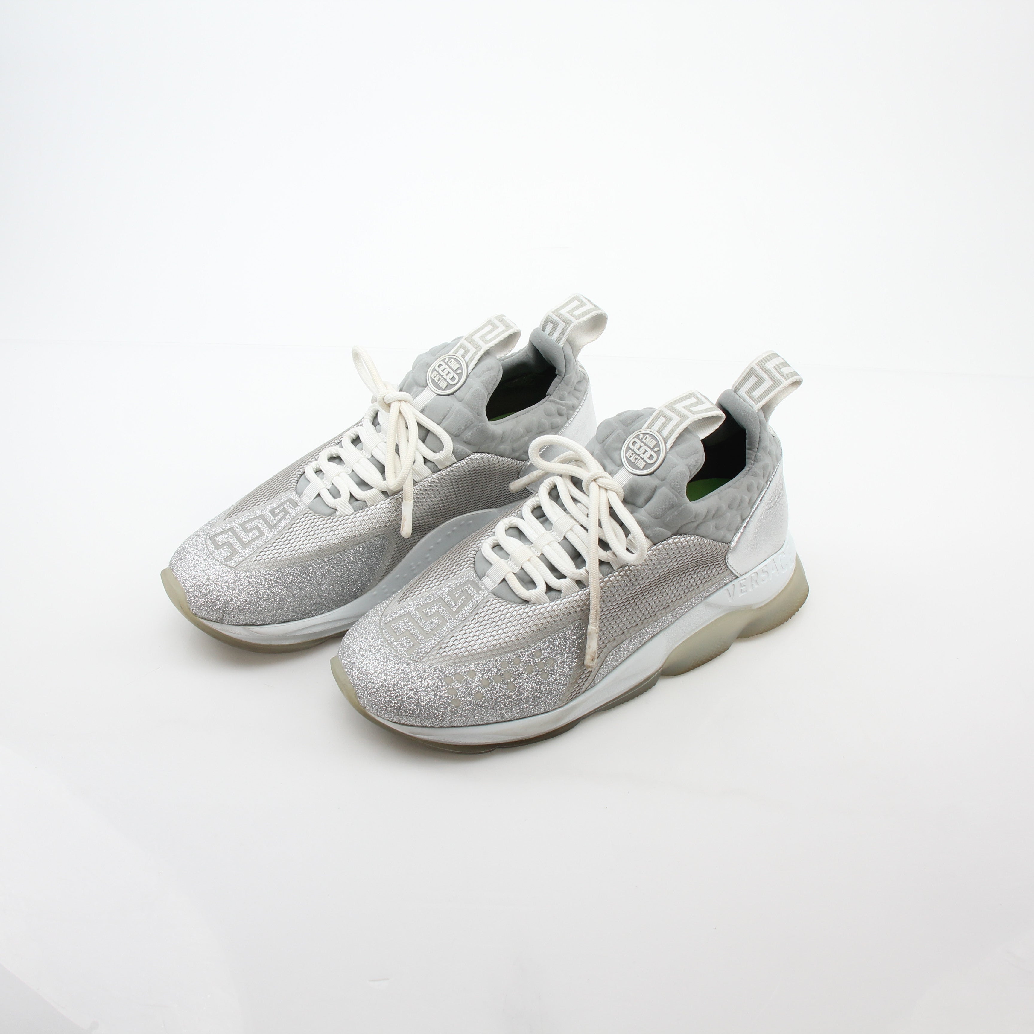 Gold & Beyond Versace Silver Chain Reaction Glitter low-top sneakers with metallic finish and stylish design.