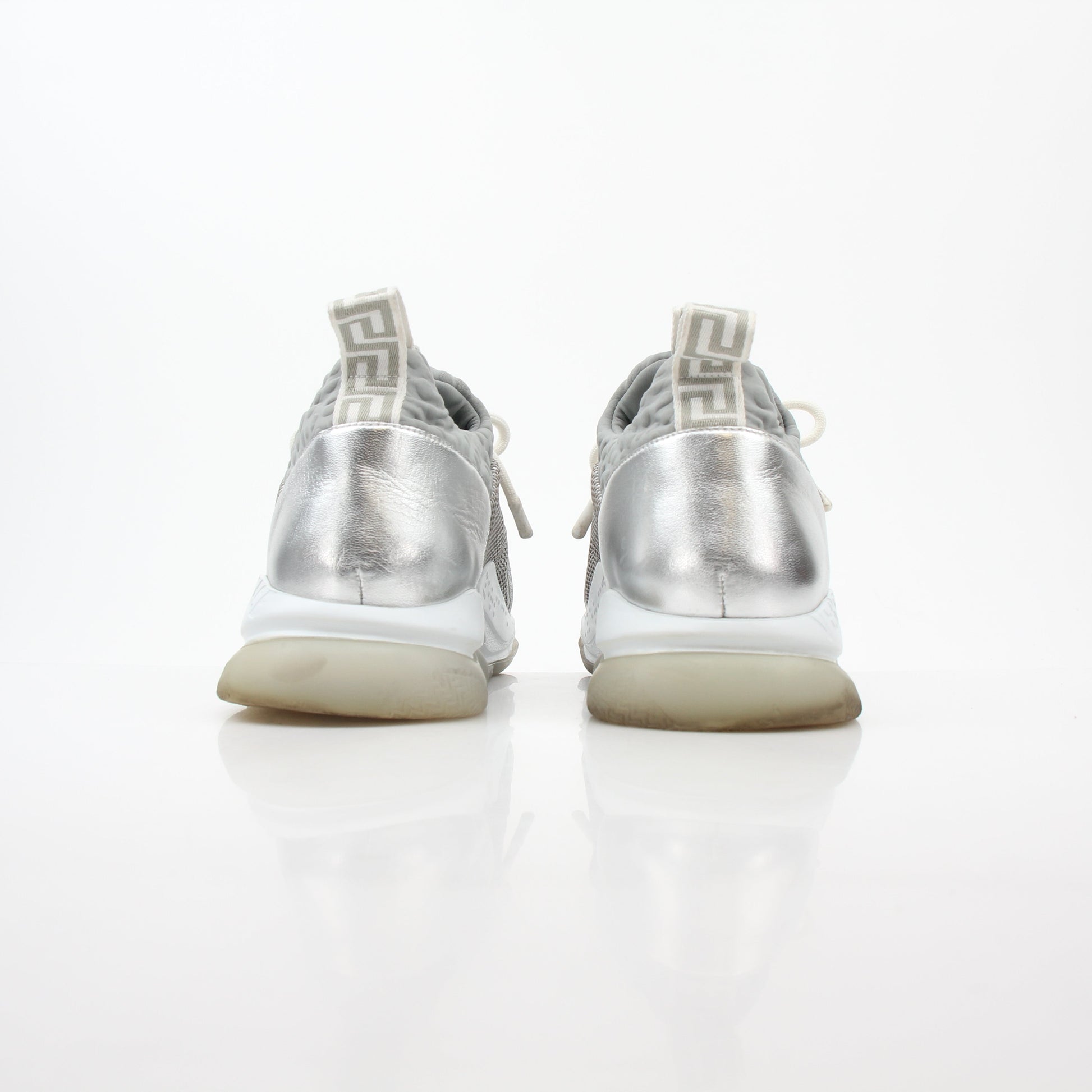 Versace Silver Chain Reaction glitter low-top sneakers from Gold & Beyond, featuring shiny silver finish and stylish design.