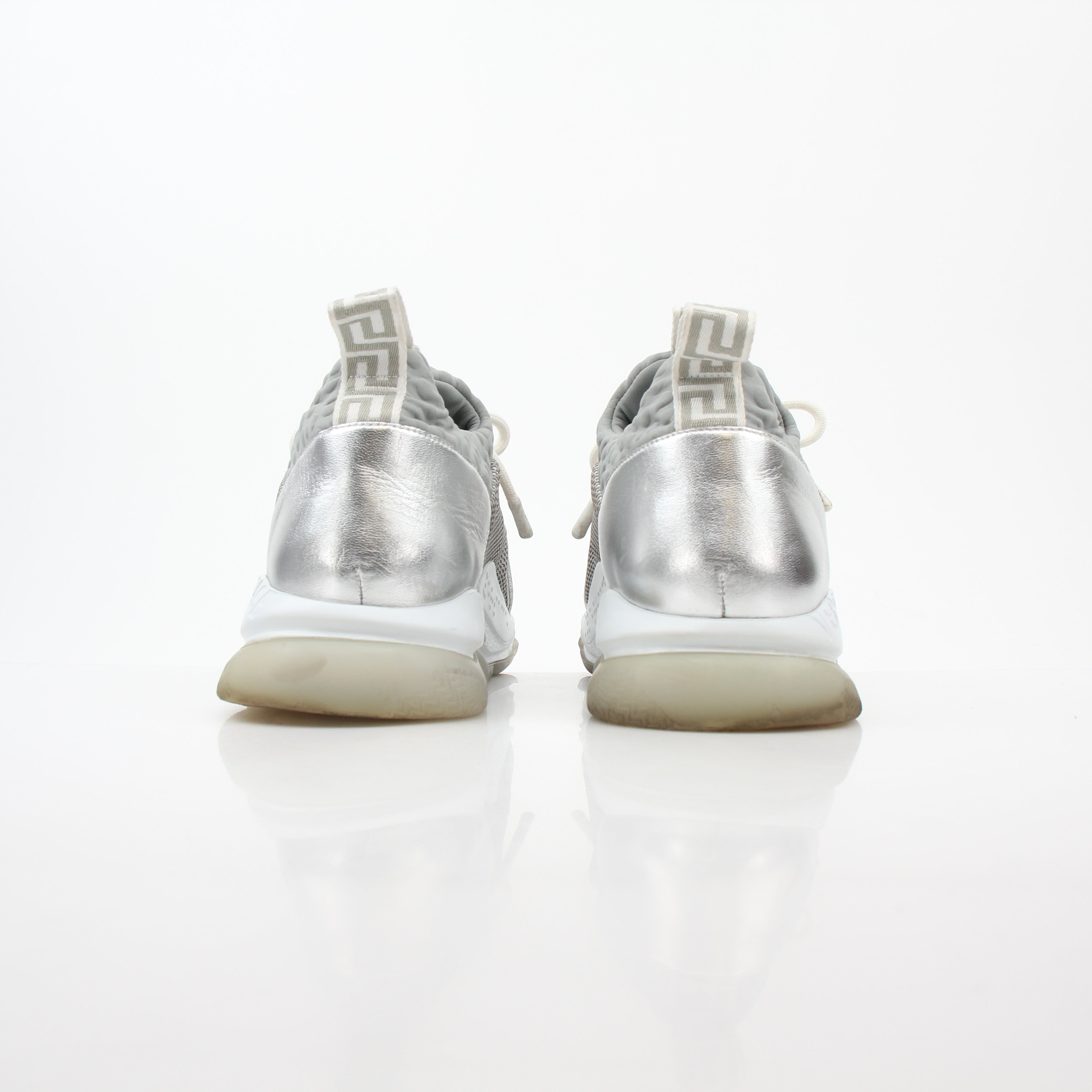 Versace Silver Chain Reaction glitter low-top sneakers from Gold & Beyond, featuring shiny silver finish and stylish design.