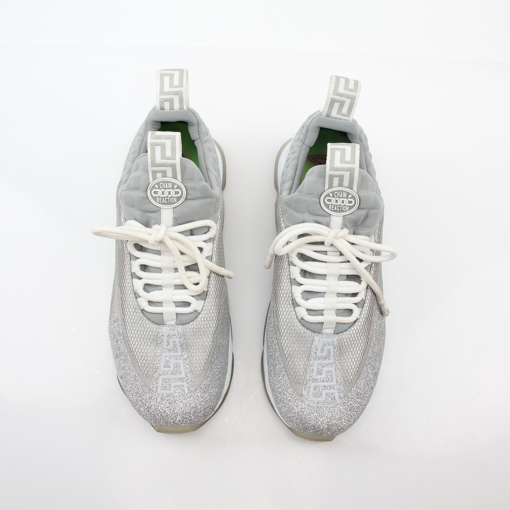 Versace Silver Chain Reaction Glitter low-top sneakers by Gold & Beyond, featuring shiny silver accents and stylish sneaker design.