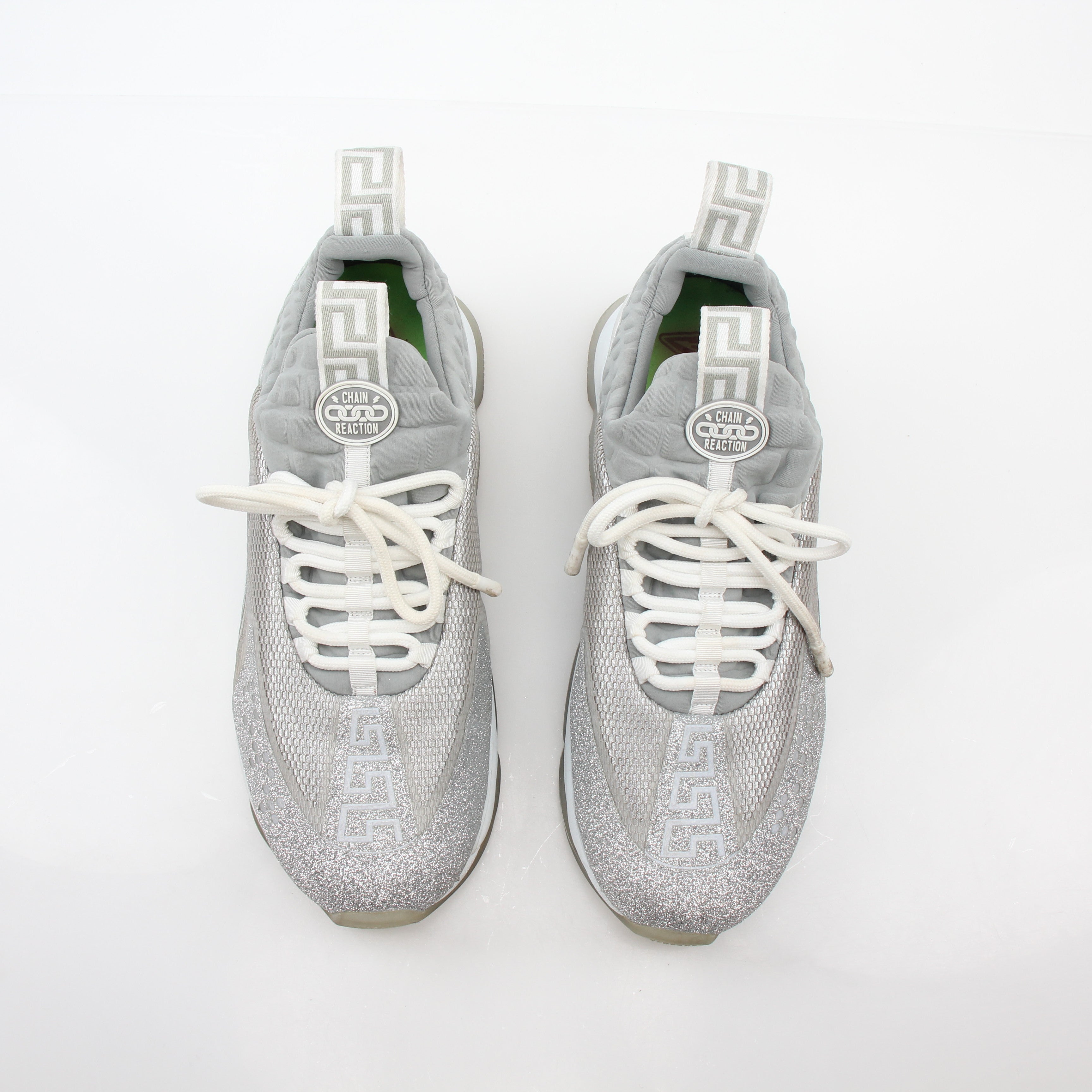 Versace Silver Chain Reaction Glitter low-top sneakers by Gold & Beyond, featuring shiny silver accents and stylish sneaker design.