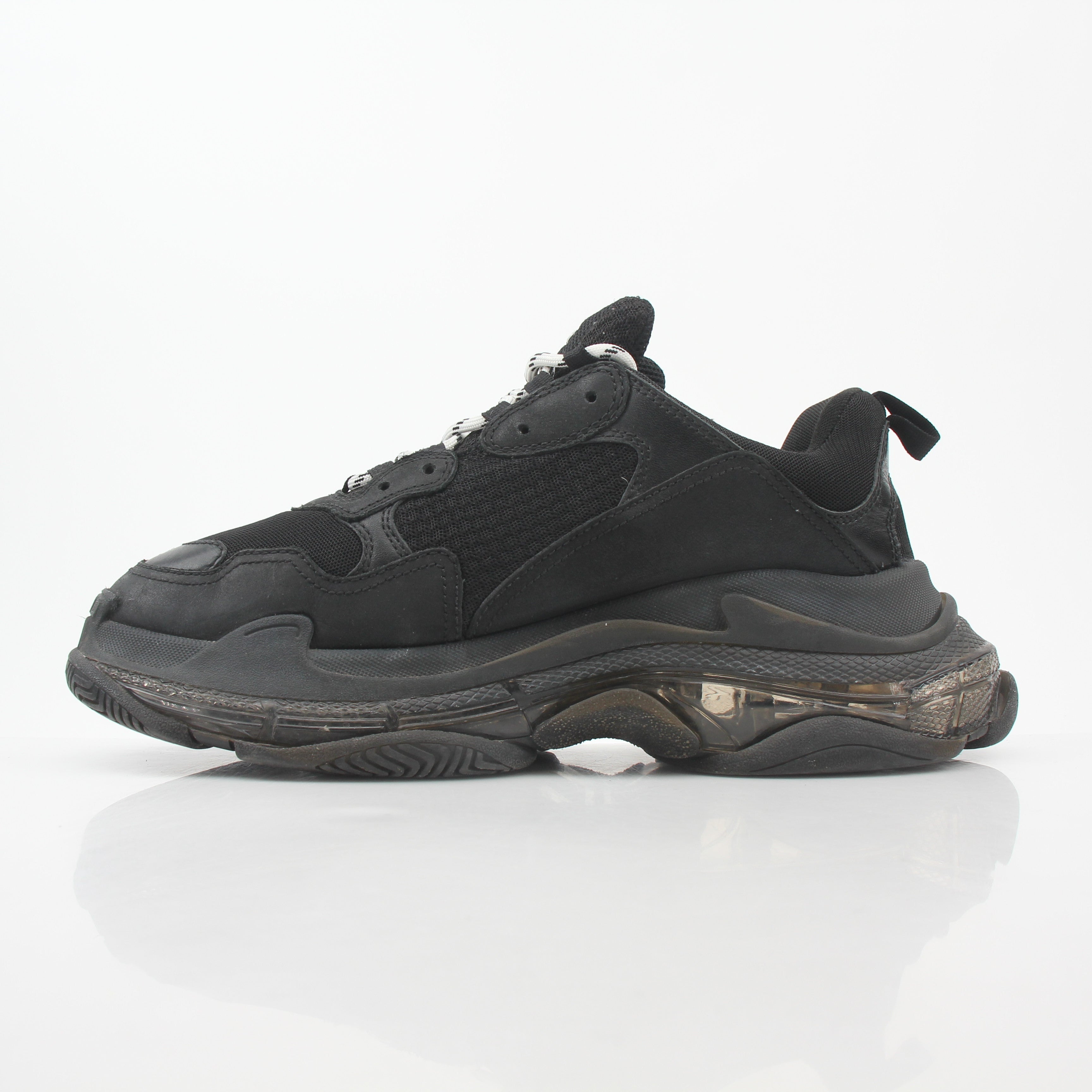 Balenciaga Black Triple S sneakers with clear soles, showcasing chunky design and brand logo on the shoes.