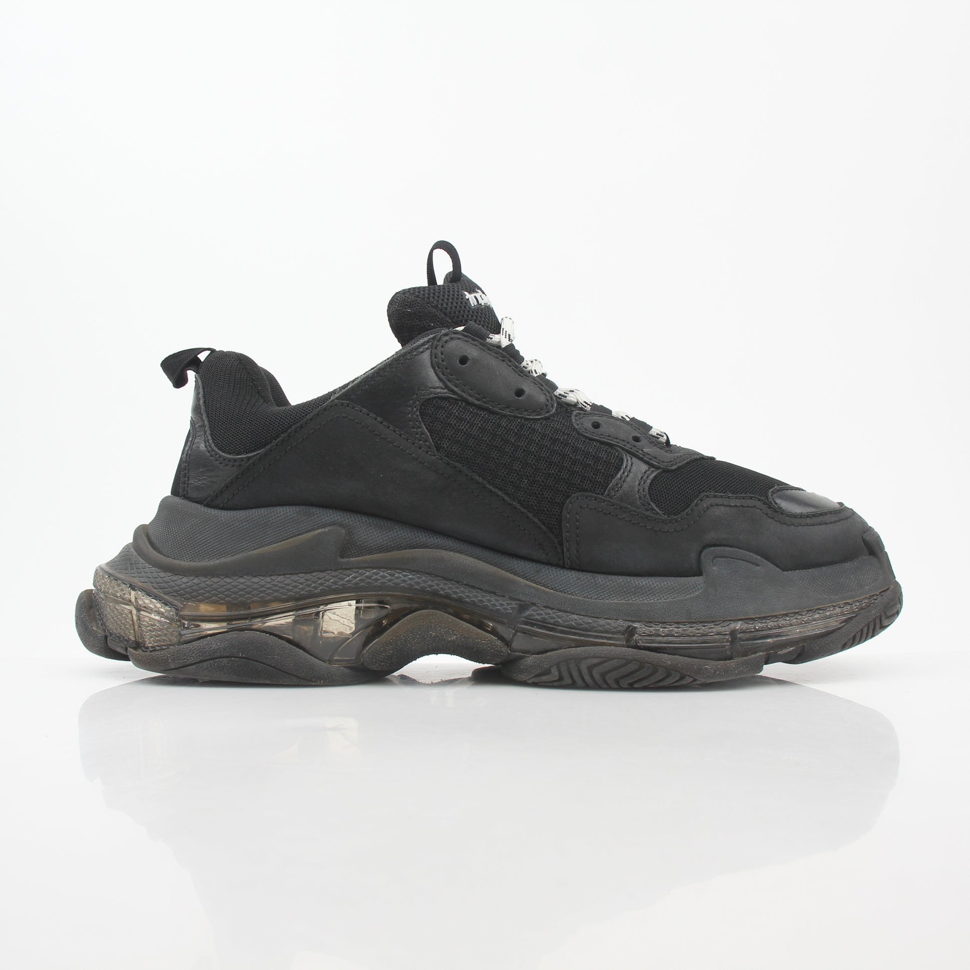 Black Balenciaga Triple S sneakers with clear soles, showcasing chunky design and athletic style from Gold & Beyond.