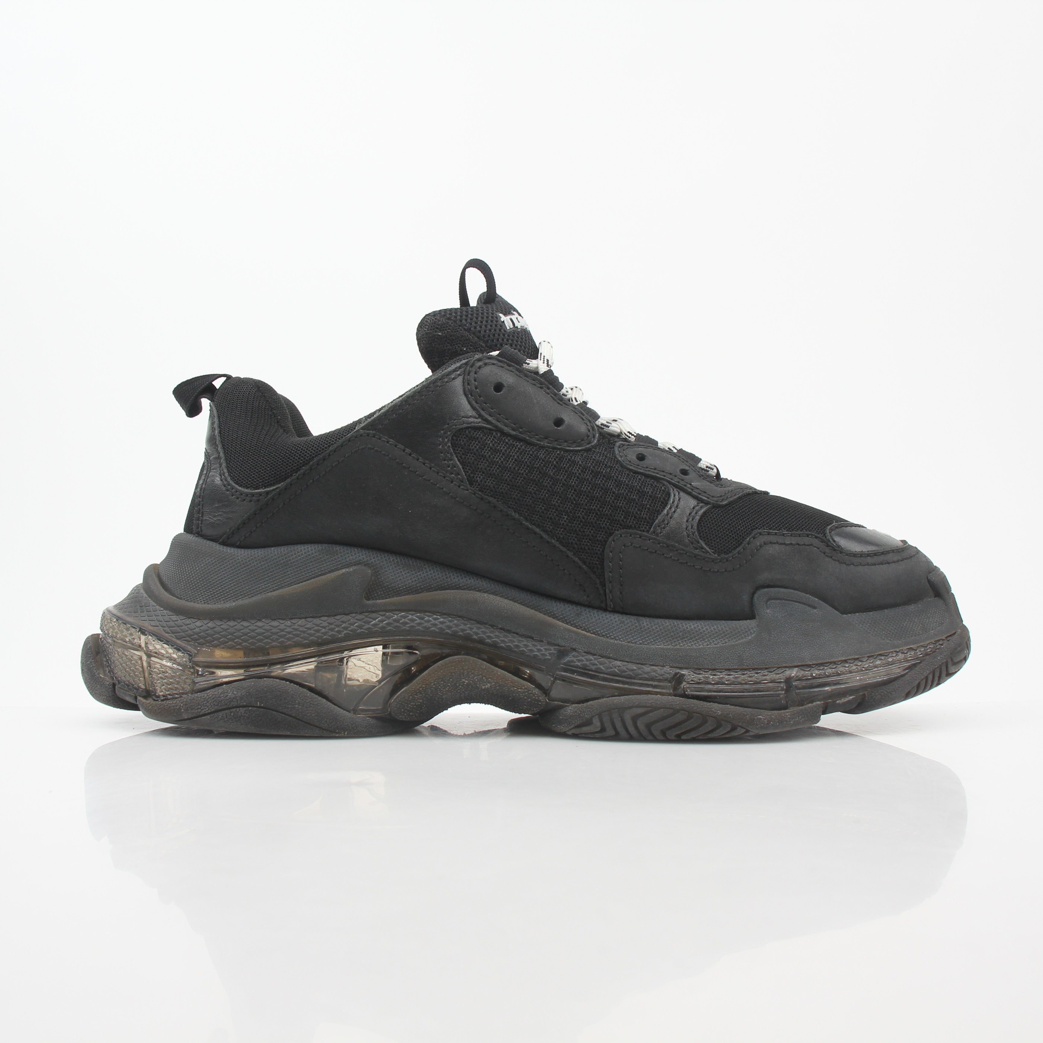 Black Balenciaga Triple S sneakers with clear soles, showcasing chunky design and athletic style from Gold & Beyond.