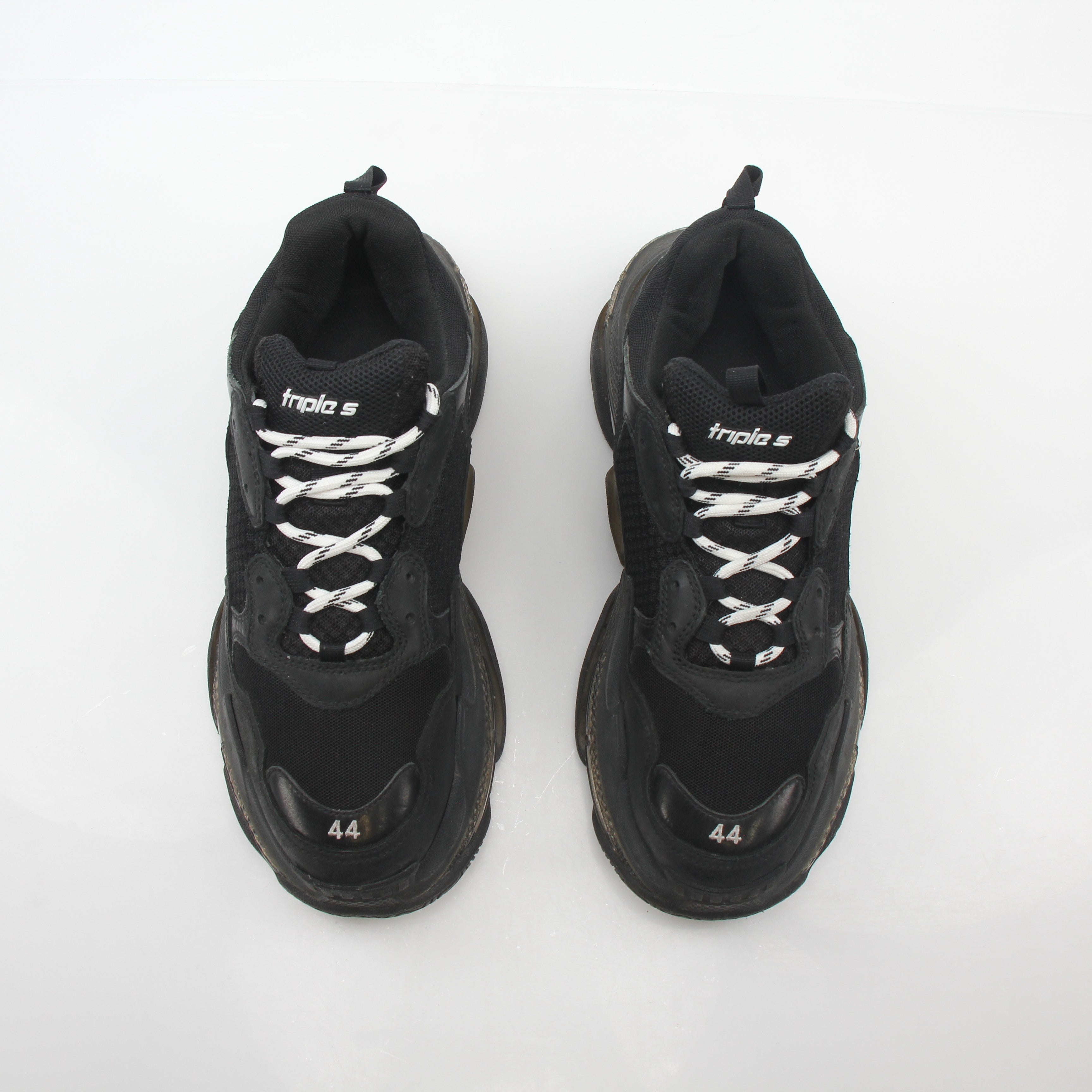 Balenciaga Black Triple S sneakers with clear sole and chunky design, displayed on a white background.