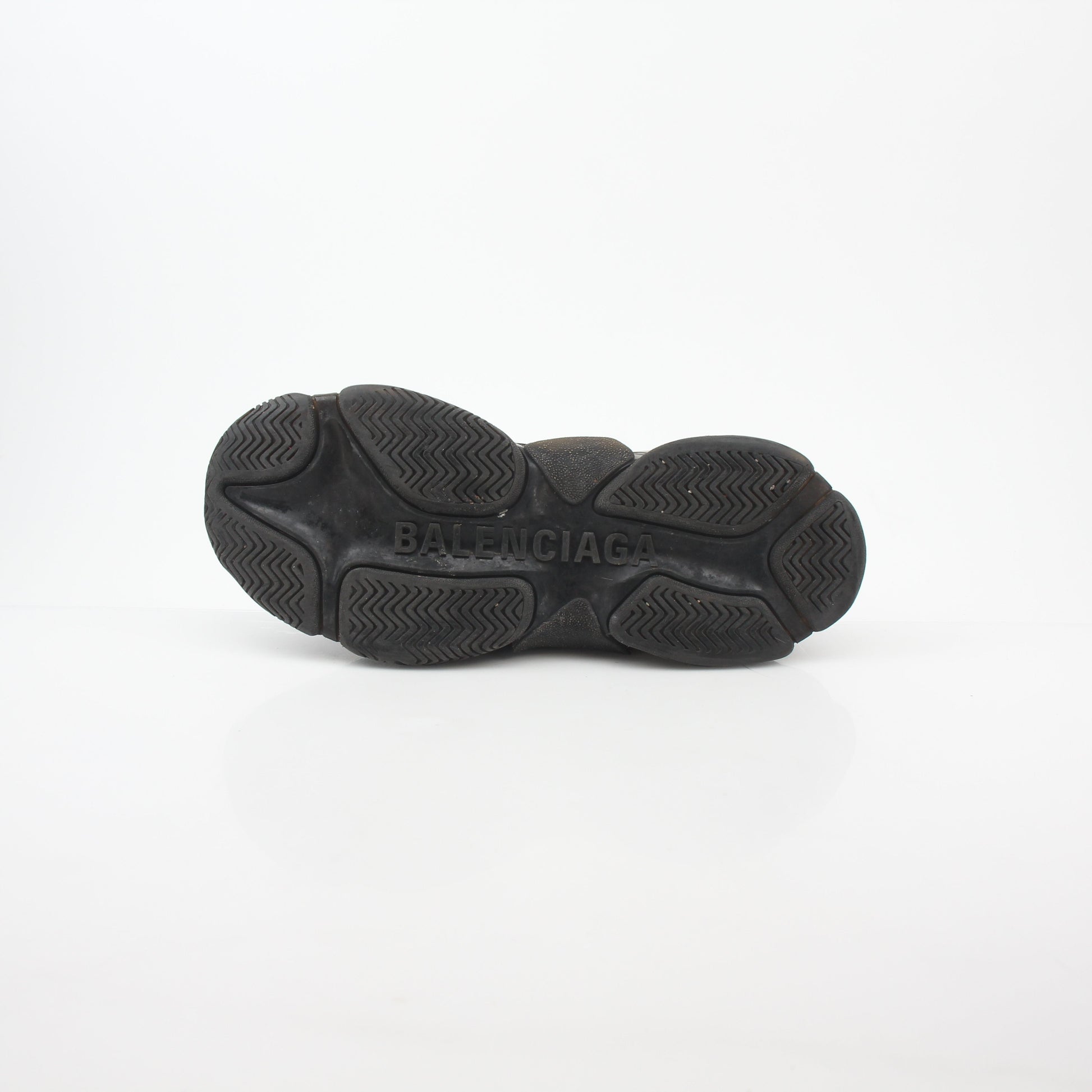 Gold & Beyond black Balenciaga Triple S sneakers with clear soles and chunky design, showcasing a fashionable shoe style.