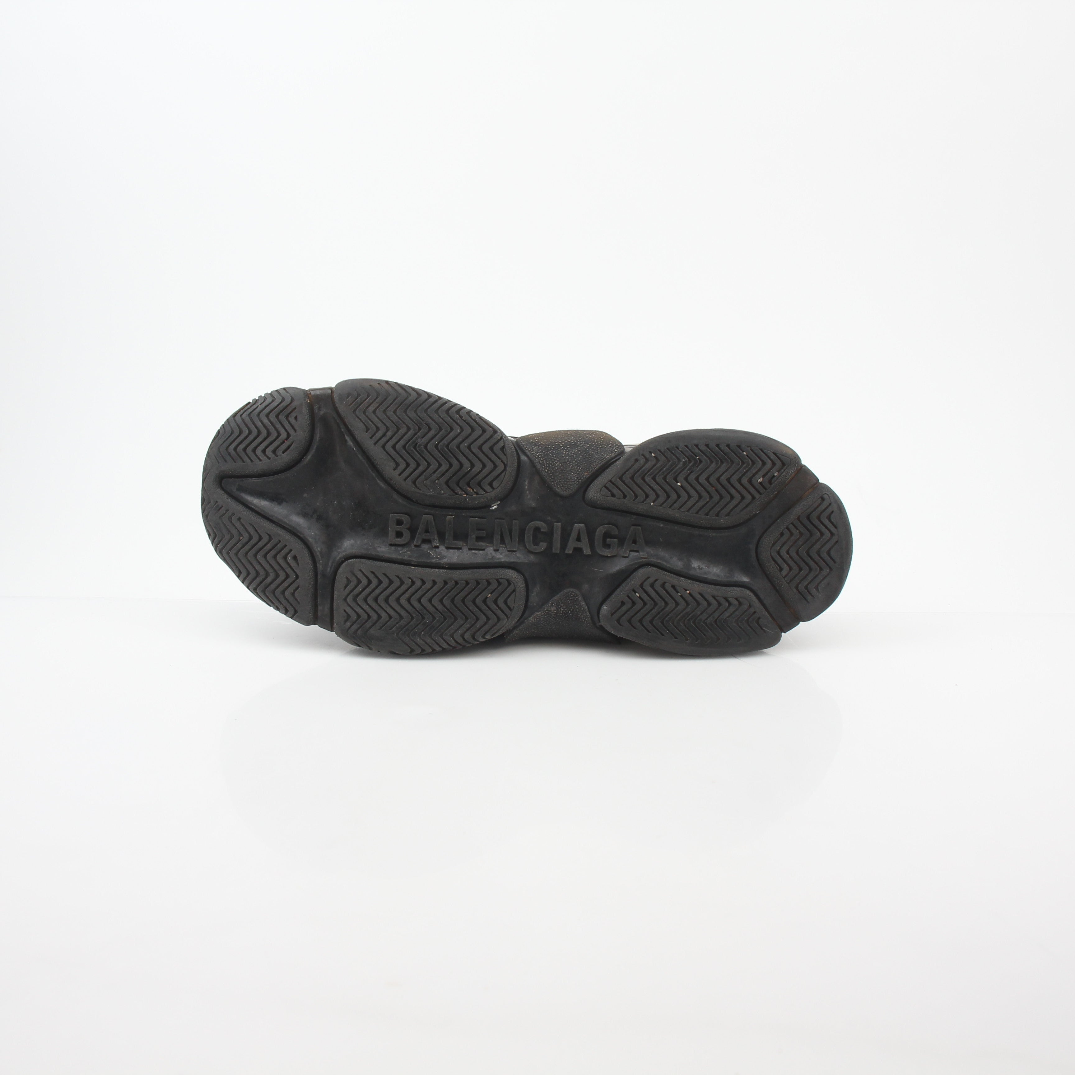 Gold & Beyond black Balenciaga Triple S sneakers with clear soles and chunky design, showcasing a fashionable shoe style.