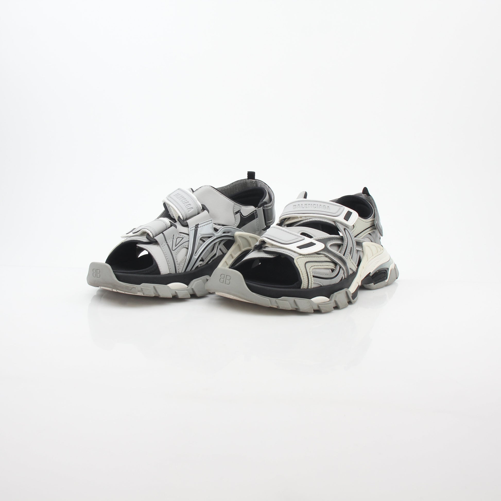 Grey Balenciaga track sandals with sporty design and thick soles, photographed from a side angle.