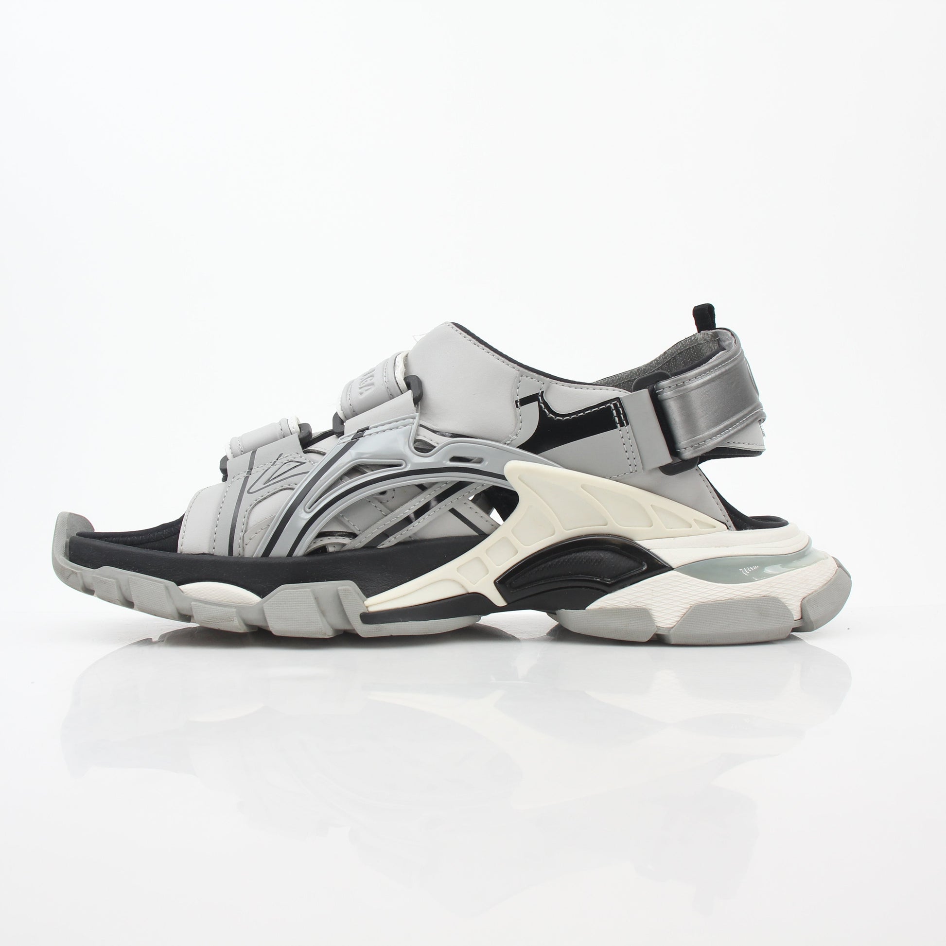 Gray Balenciaga track sandals featuring sporty design and chunky sole, worn on a model's feet.