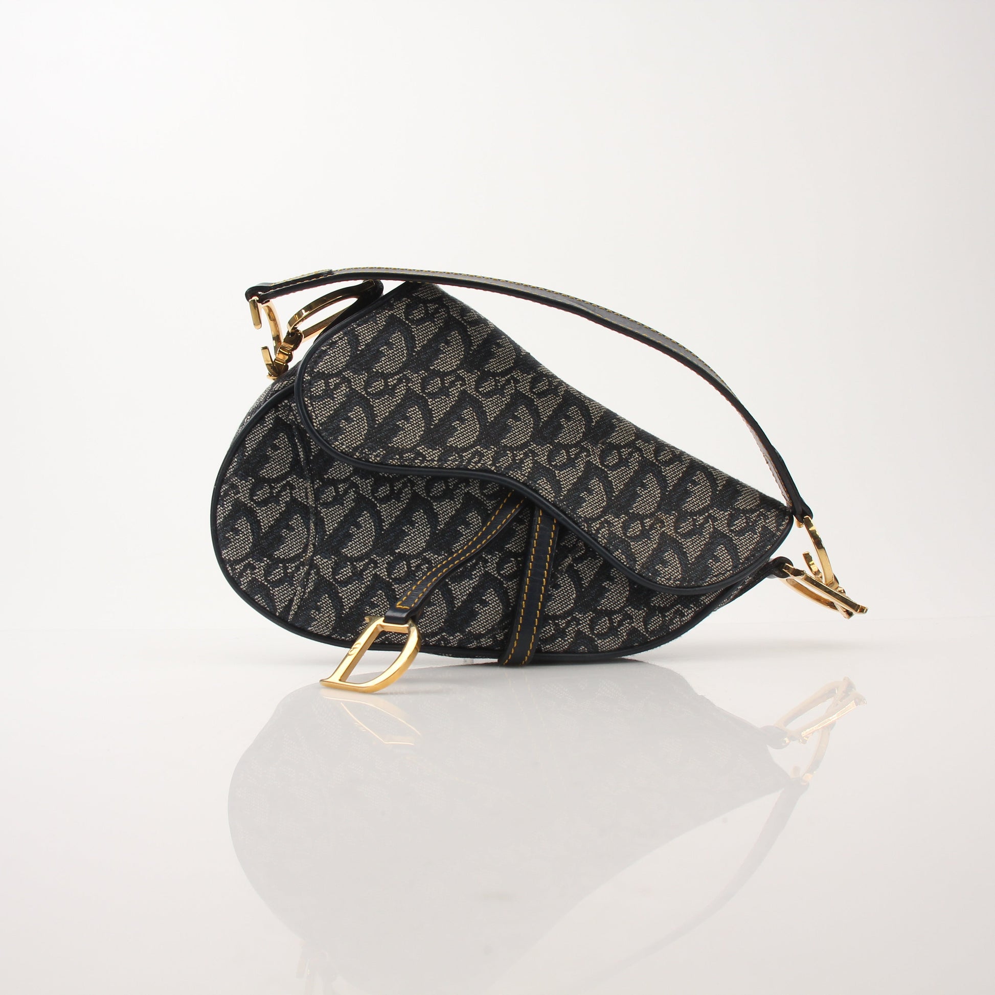Gold & Beyond Christian Dior Mini Saddle Bag handbag with gold accents, compact design, and signature Dior style.