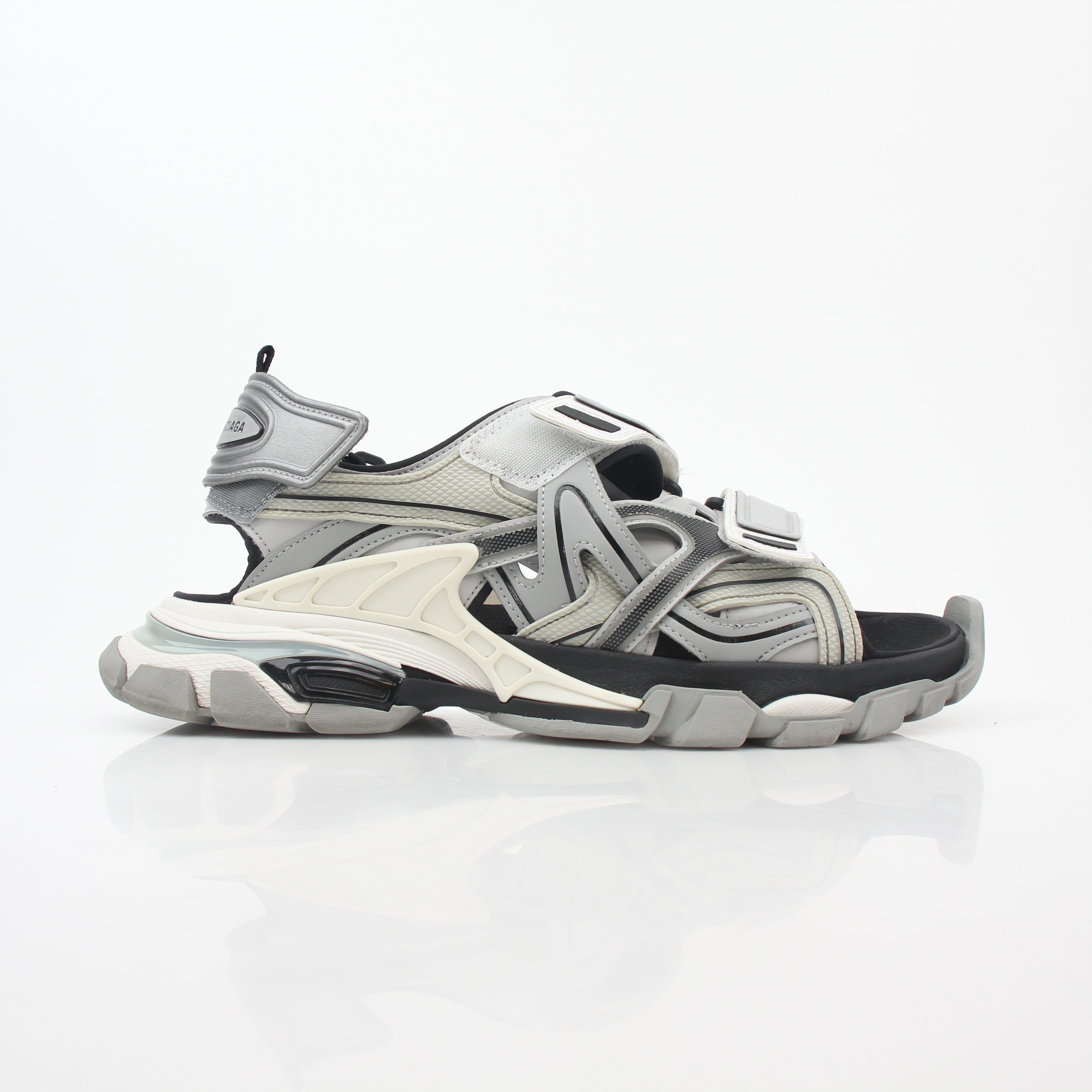 Grey Balenciaga track sandals by Gold & Beyond, featuring sporty straps and chunky soles, laid out on a neutral background.