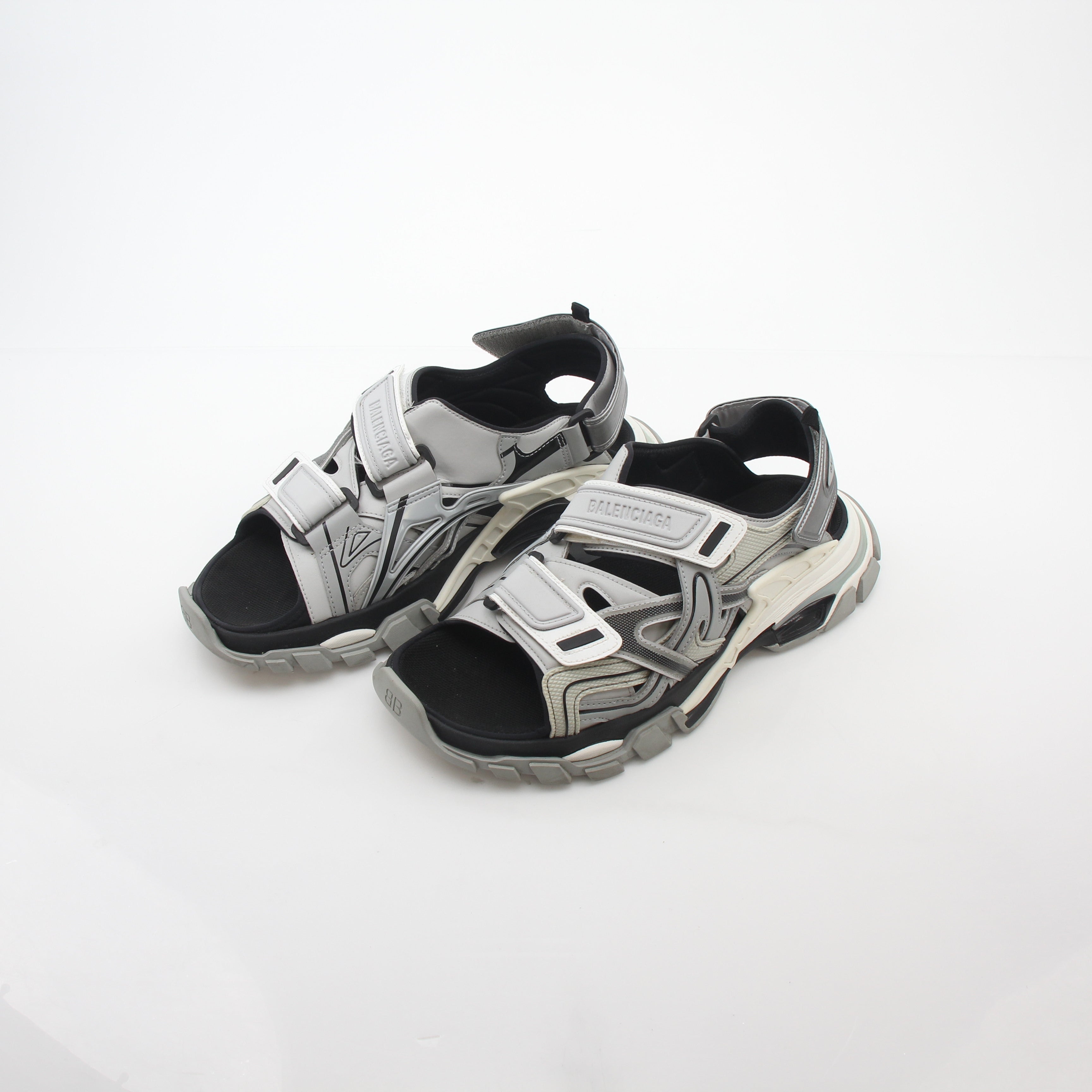Grey Balenciaga track sandals featuring sporty design and chunky sole, displayed on a neutral background.