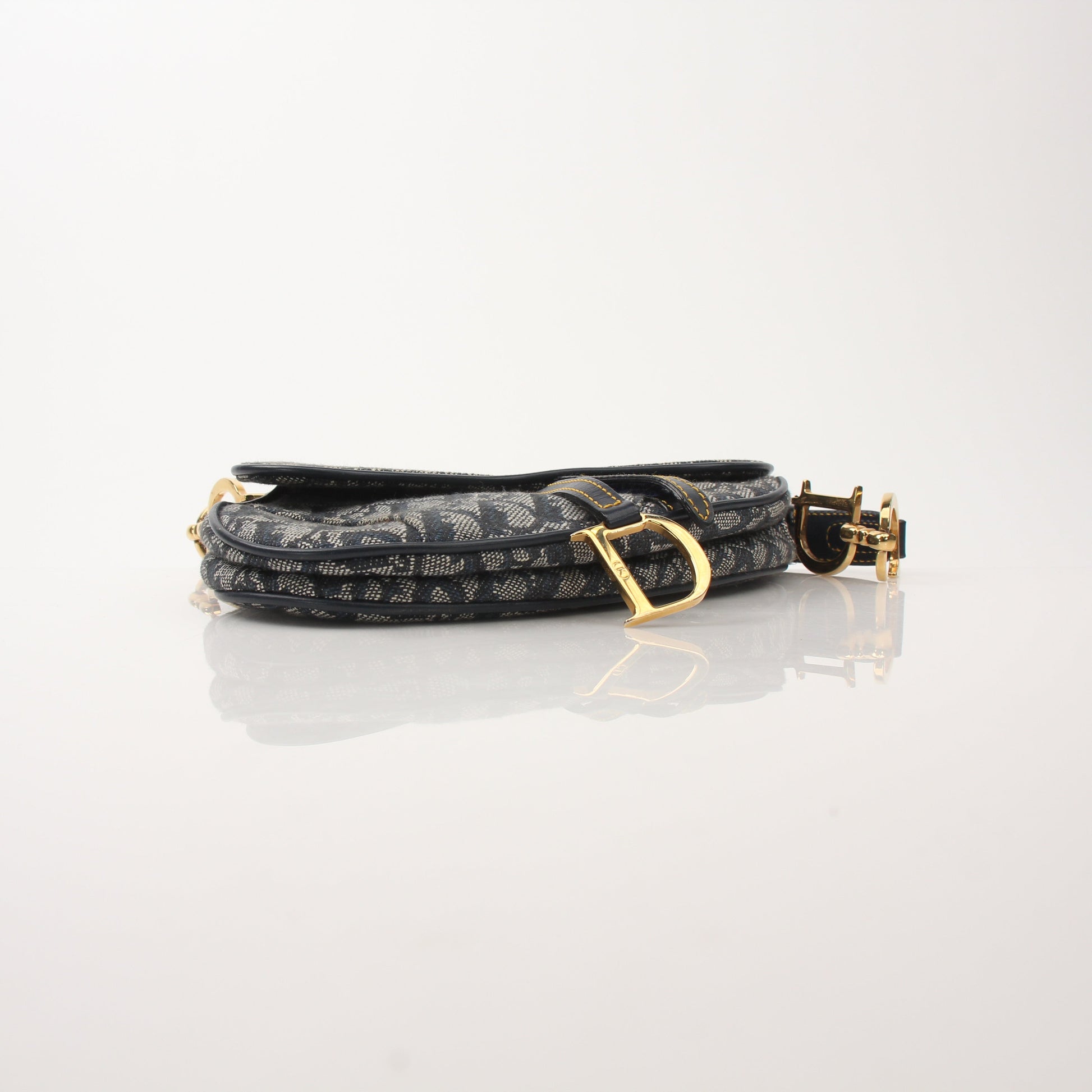 Gold & Beyond Christian Dior Mini Saddle Bag handbag with adjustable strap and signature saddle shape.