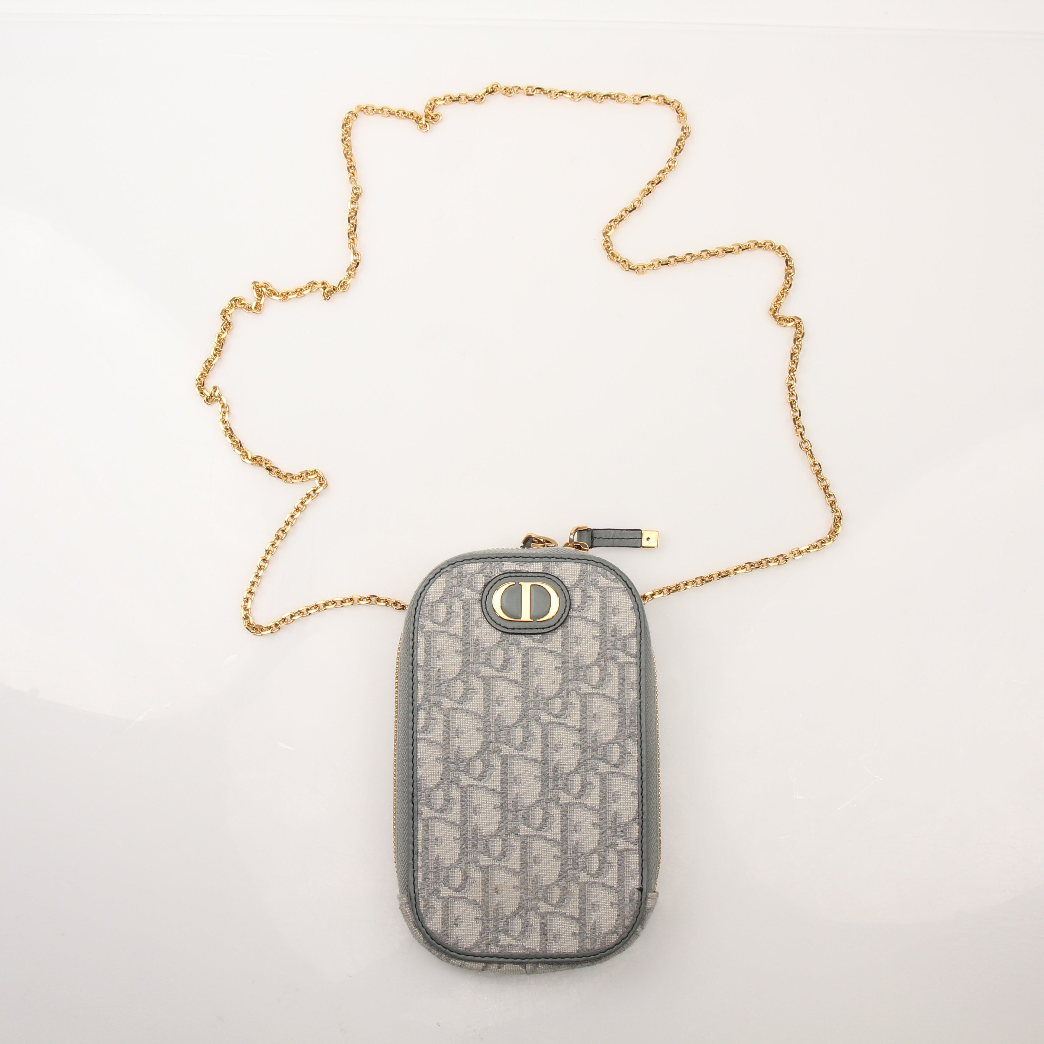 Christian Dior 30 Montaigne Call’in Dior phone holder handbag with gold accents and sleek design, by Gold & Beyond.