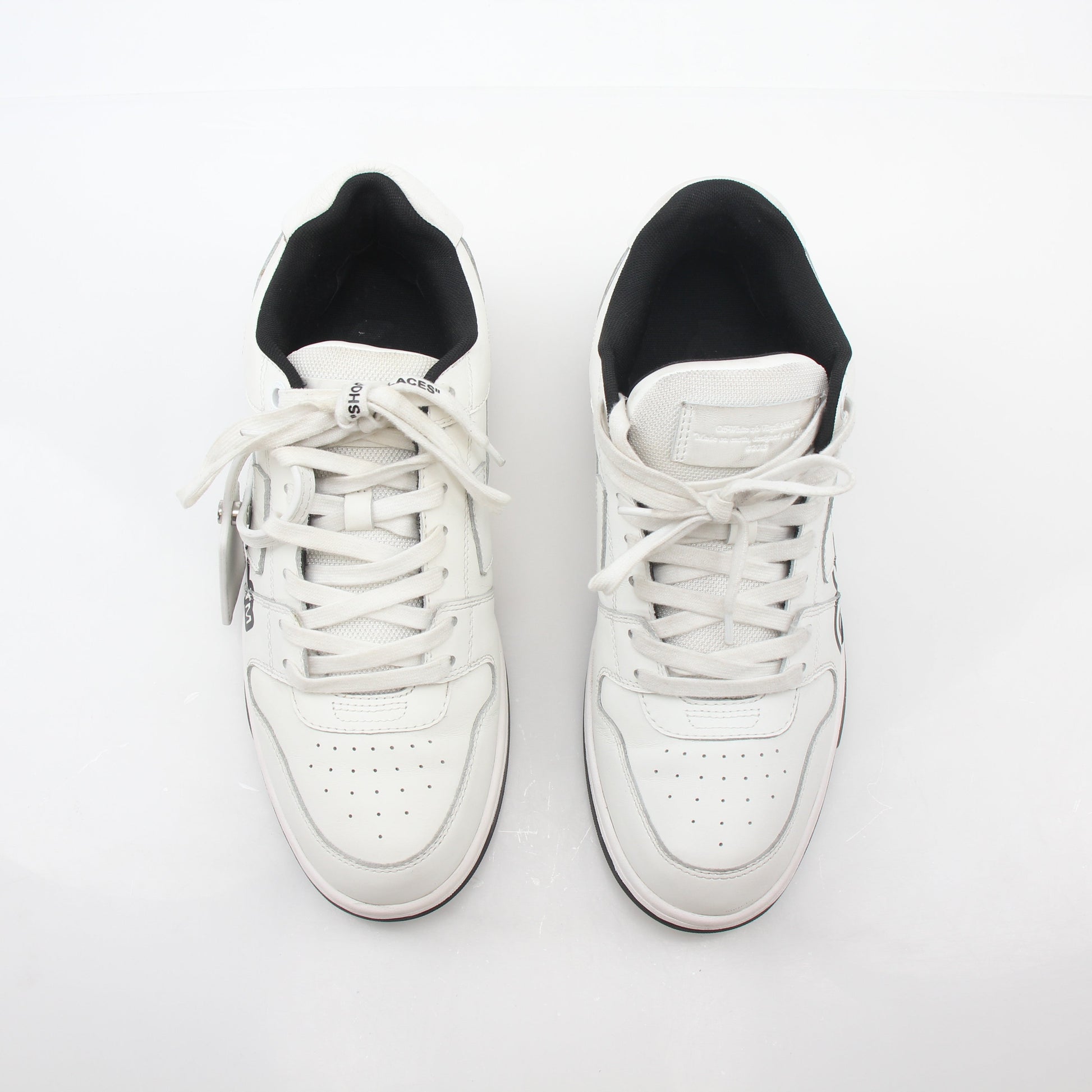 Off-White White Out Of Office graffiti logo sneakers, shoes with bold design and branding, displayed on a plain background.