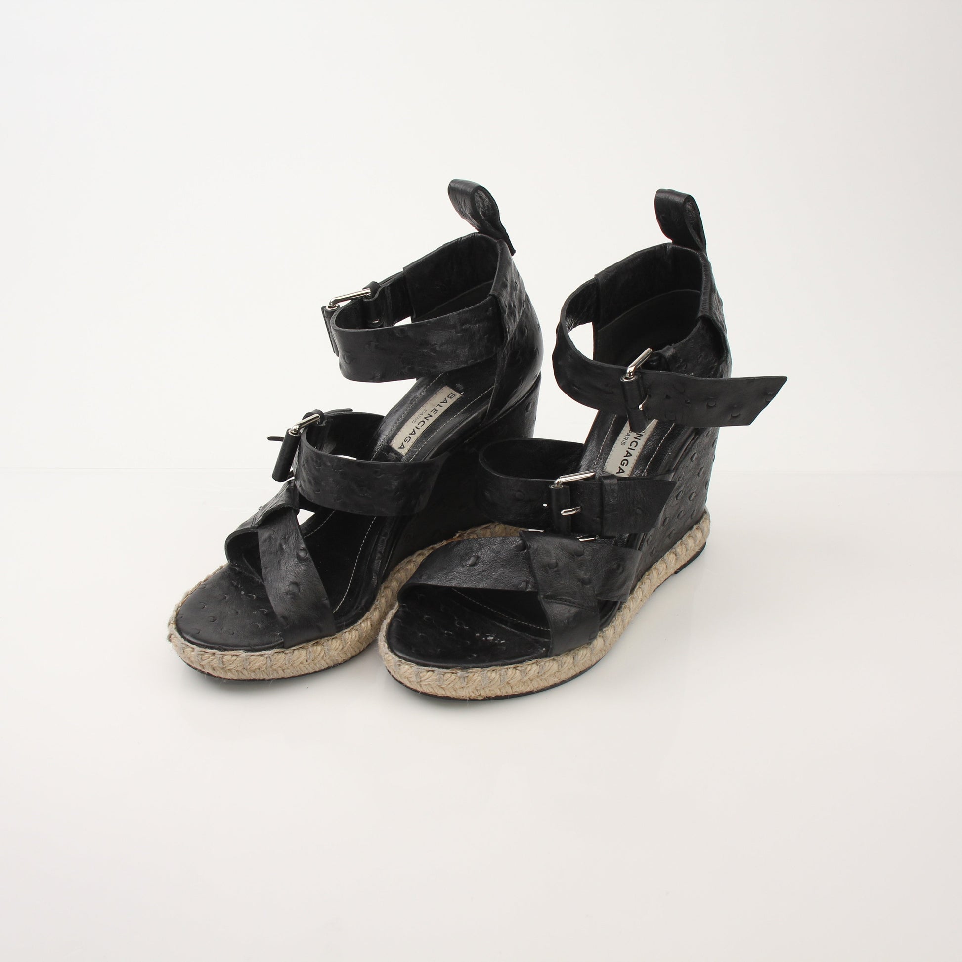 Gold & Beyond Balenciaga Ostrich Wedge Espadrille Sandals featuring black ostrich leather, woven wedge heel, and ankle strap.