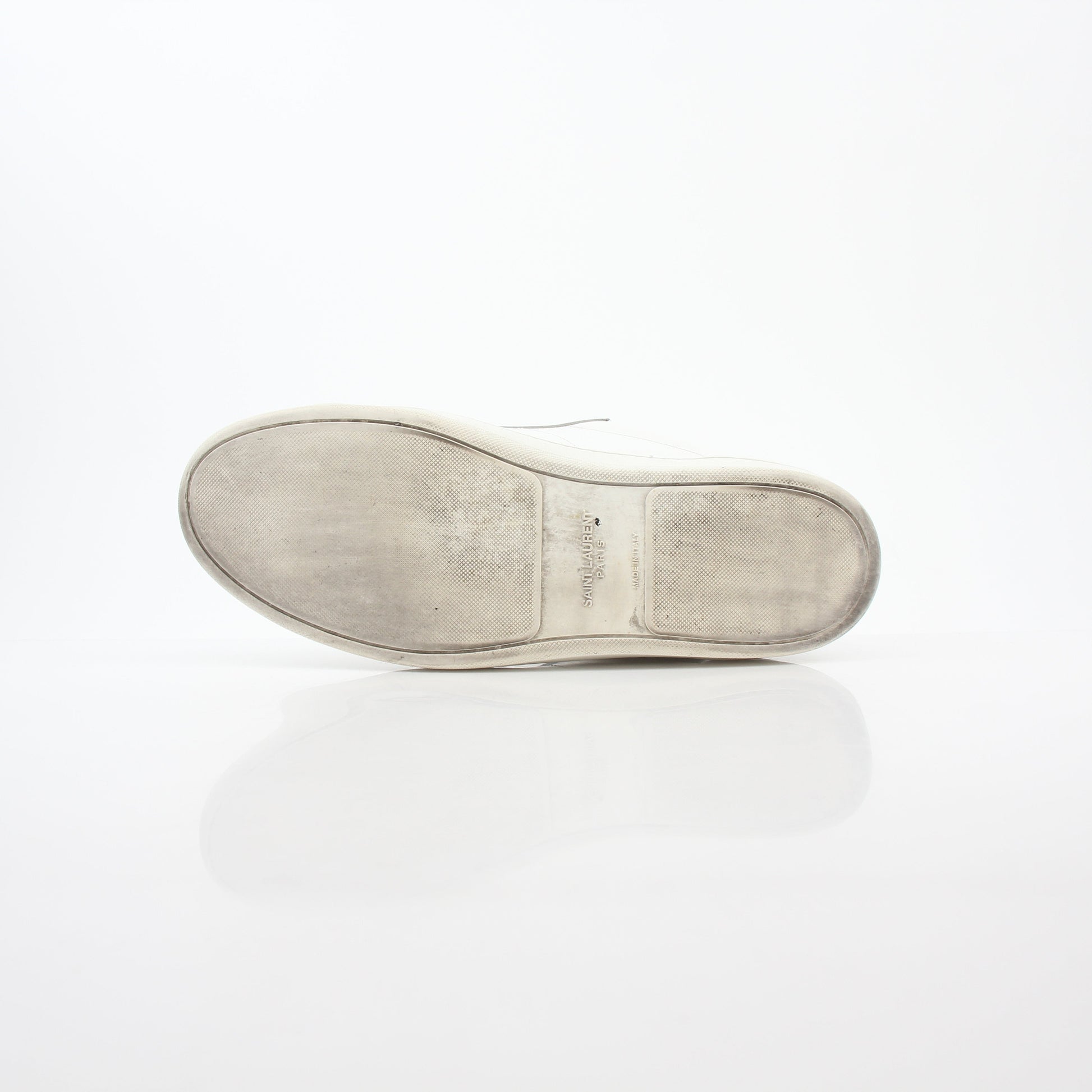 White Saint Laurent SL/06 Court Classic Sneakers with gold accents, showcasing sleek leather shoes with a modern design.
