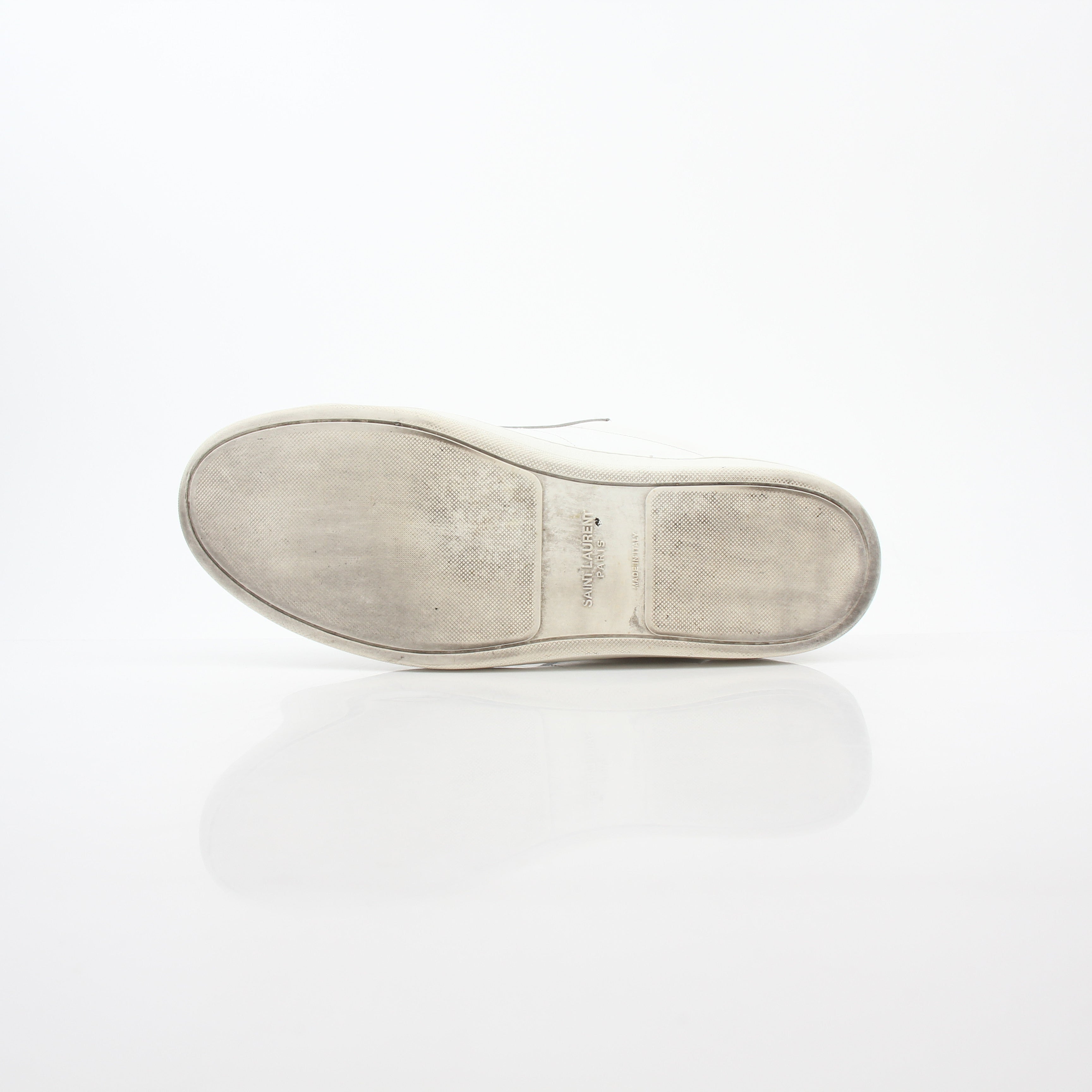 White Saint Laurent SL/06 Court Classic Sneakers with gold accents, showcasing sleek leather shoes with a modern design.