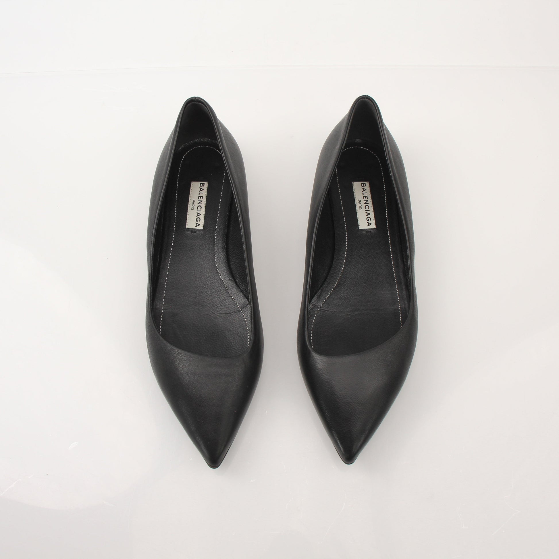 Gold & Beyond leather pointed-toe flats featuring sleek design and elegant stitching, perfect for stylish footwear.