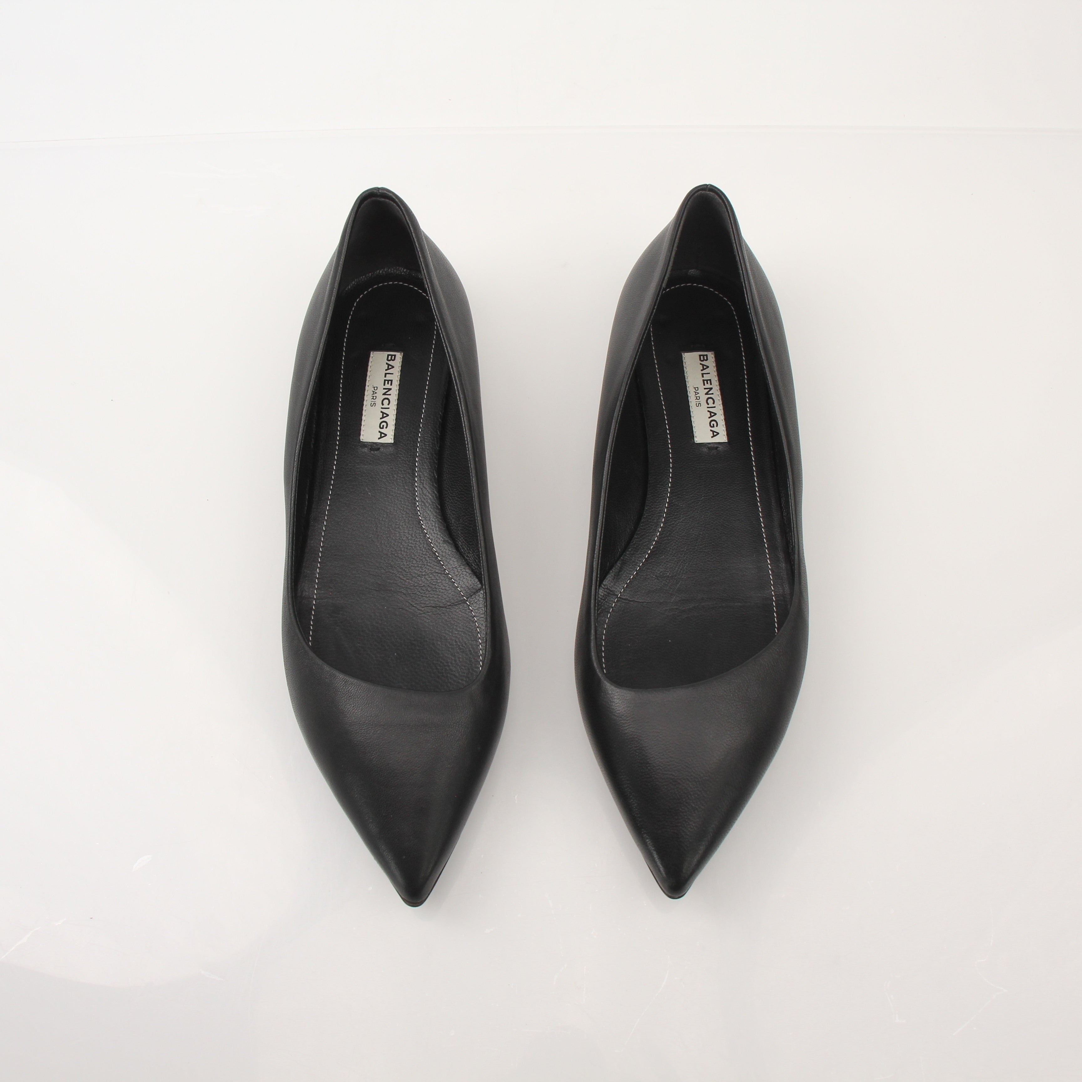 Gold & Beyond leather pointed-toe flats featuring sleek design and elegant stitching, perfect for stylish footwear.