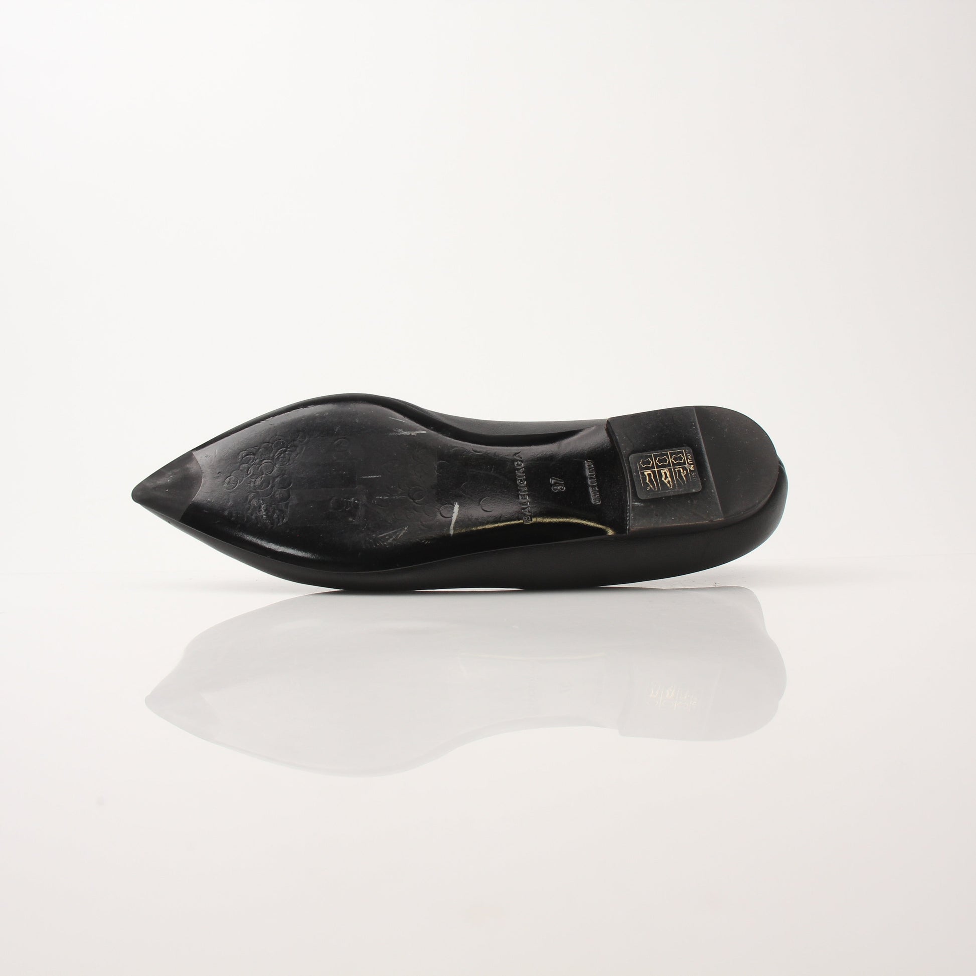 Gold & Beyond Balenciaga leather pointed-toe flats featuring sleek design and elegant craftsmanship.