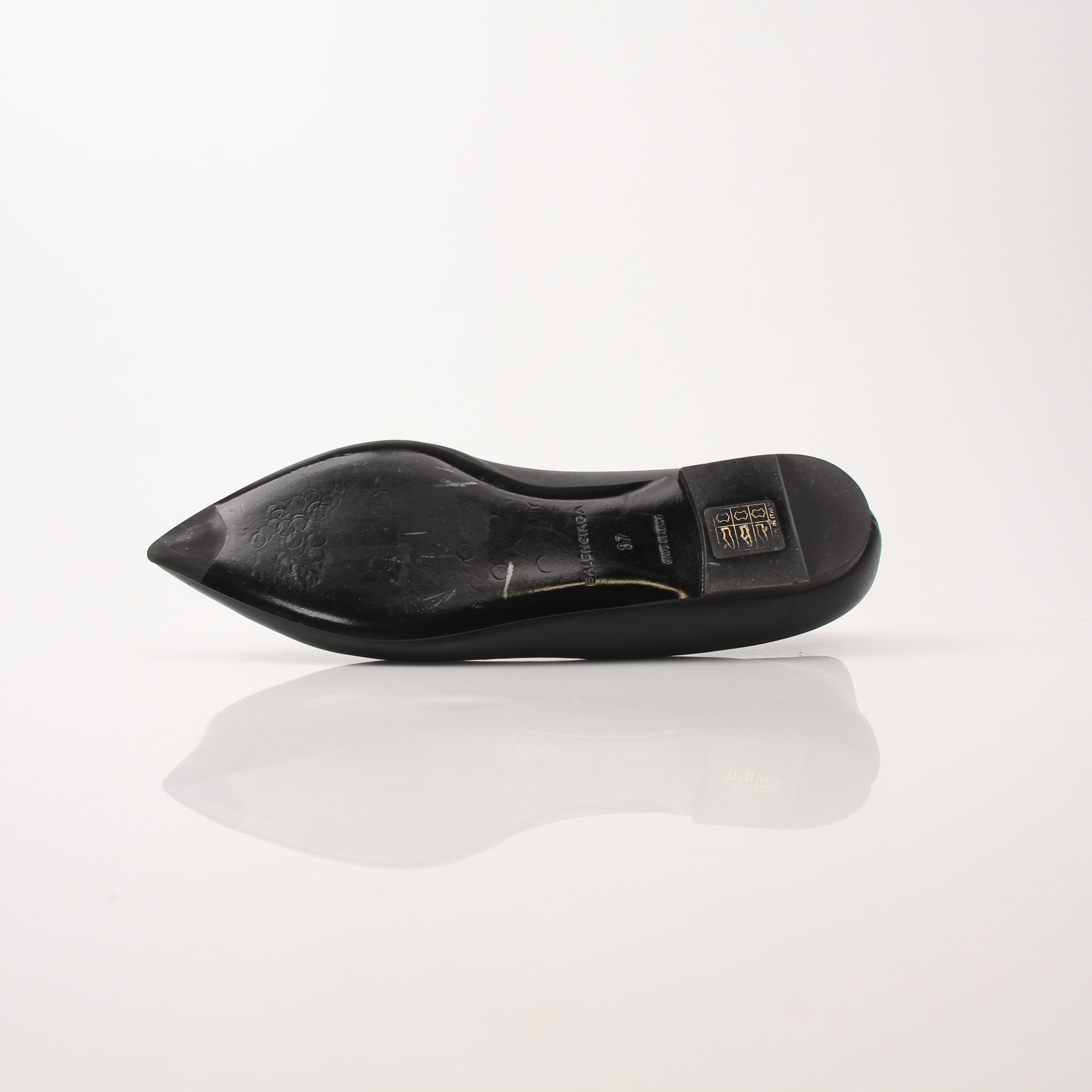 Gold & Beyond Balenciaga leather pointed-toe flats featuring sleek design and elegant craftsmanship.