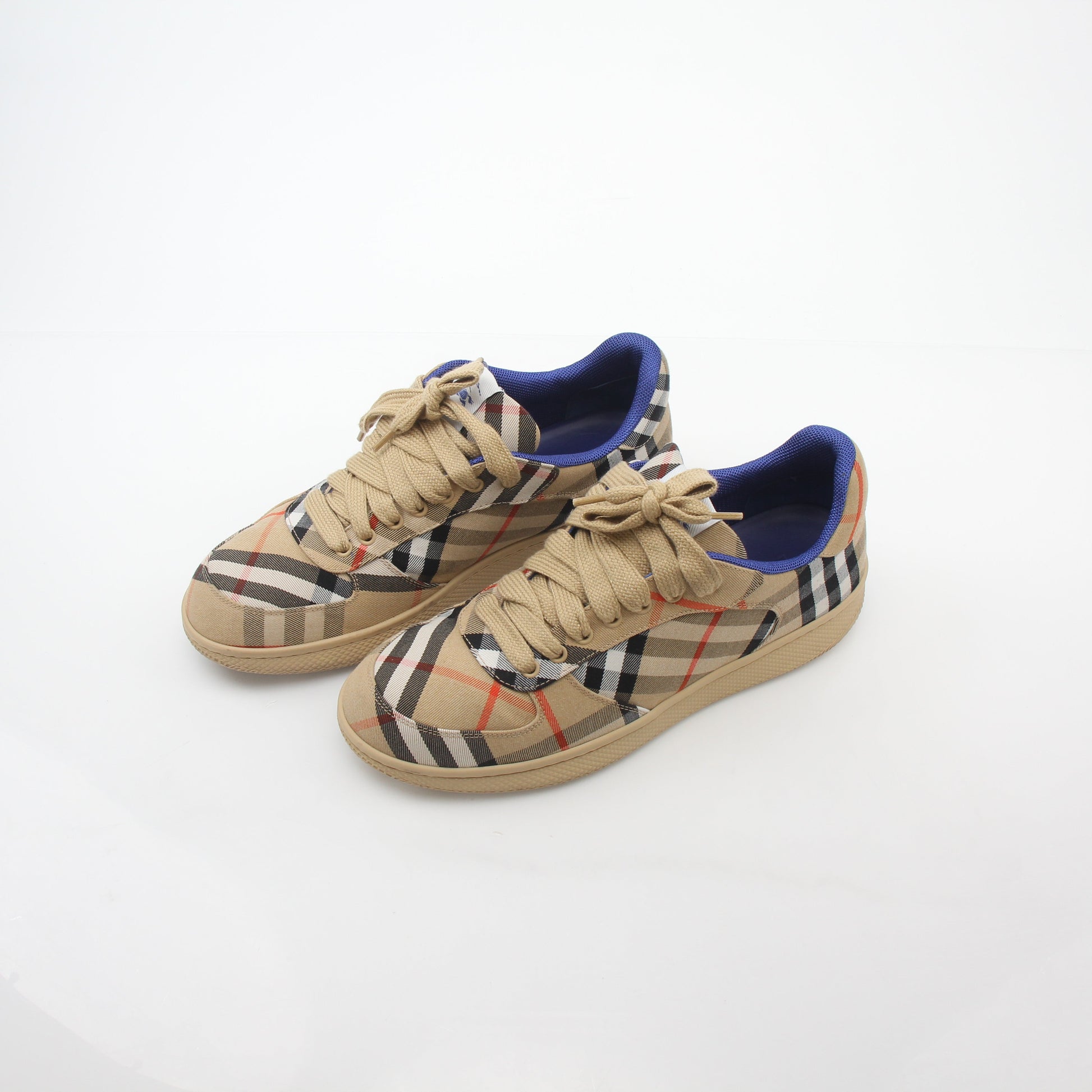 Gold & Beyond Burberry Vintage Check Terrace low-top sneakers with classic check pattern and white rubber soles.