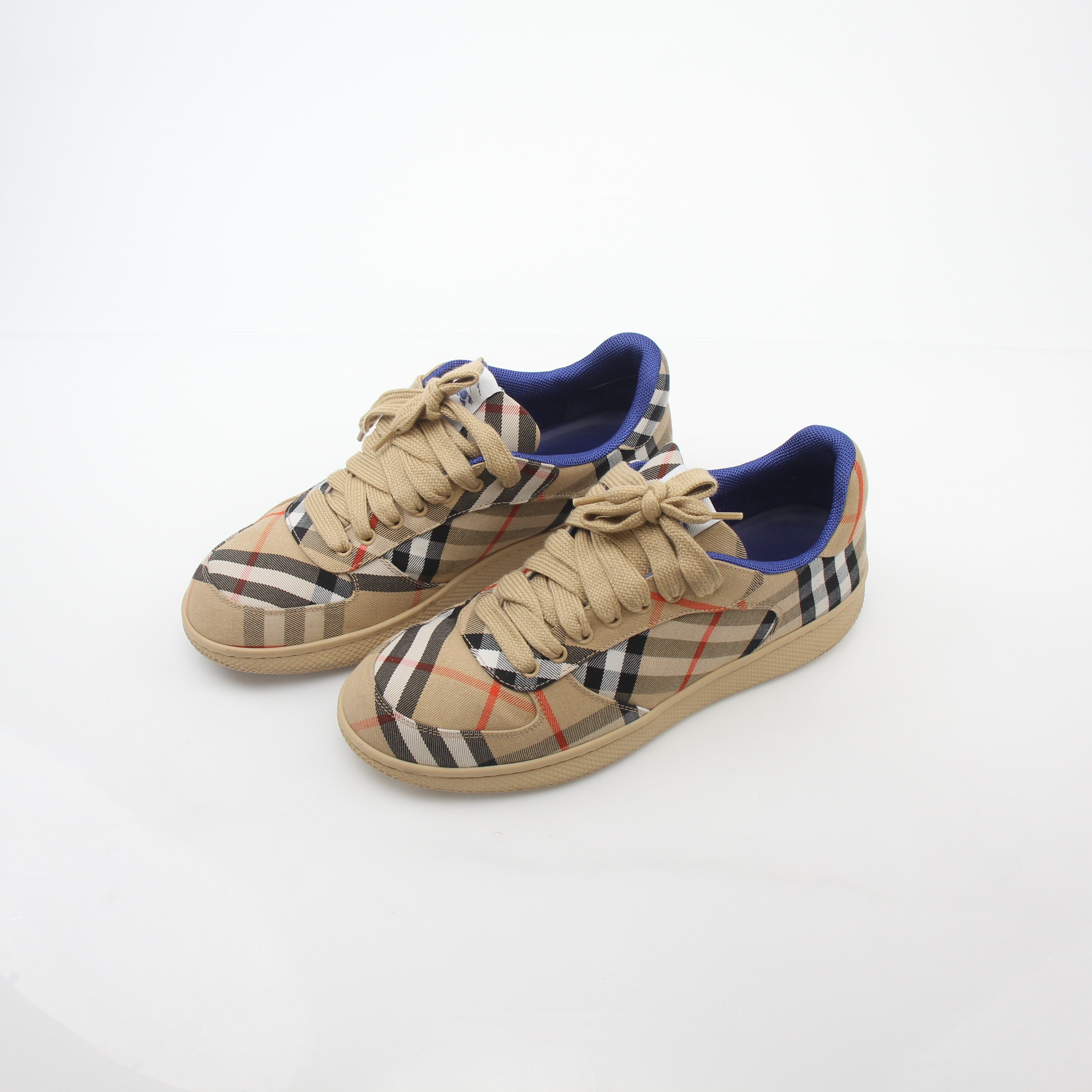 Gold & Beyond Burberry Vintage Check Terrace low-top sneakers with classic check pattern and white rubber soles.
