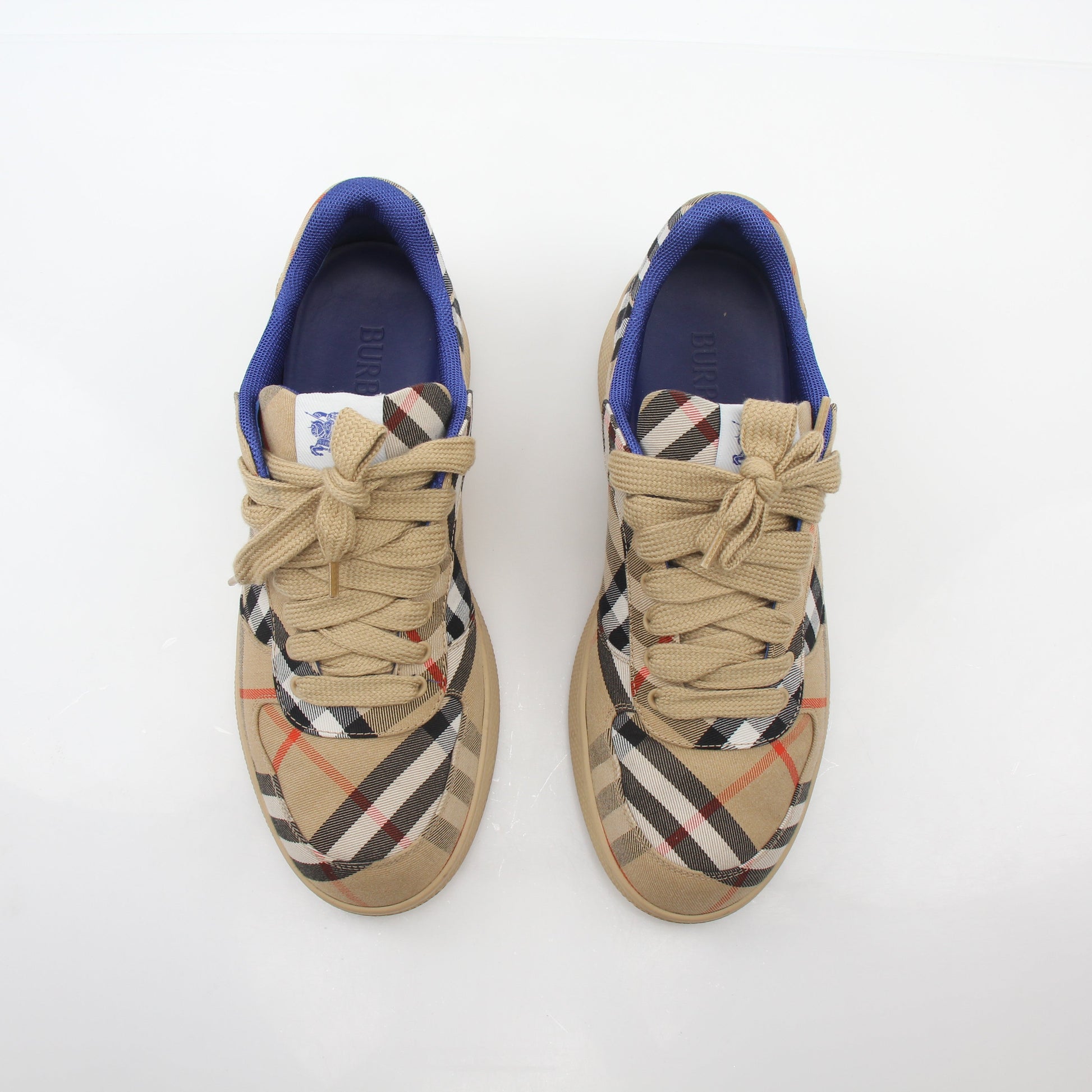 Gold & Beyond Burberry vintage check terrace low-top sneakers with beige and black plaid pattern and white rubber soles.