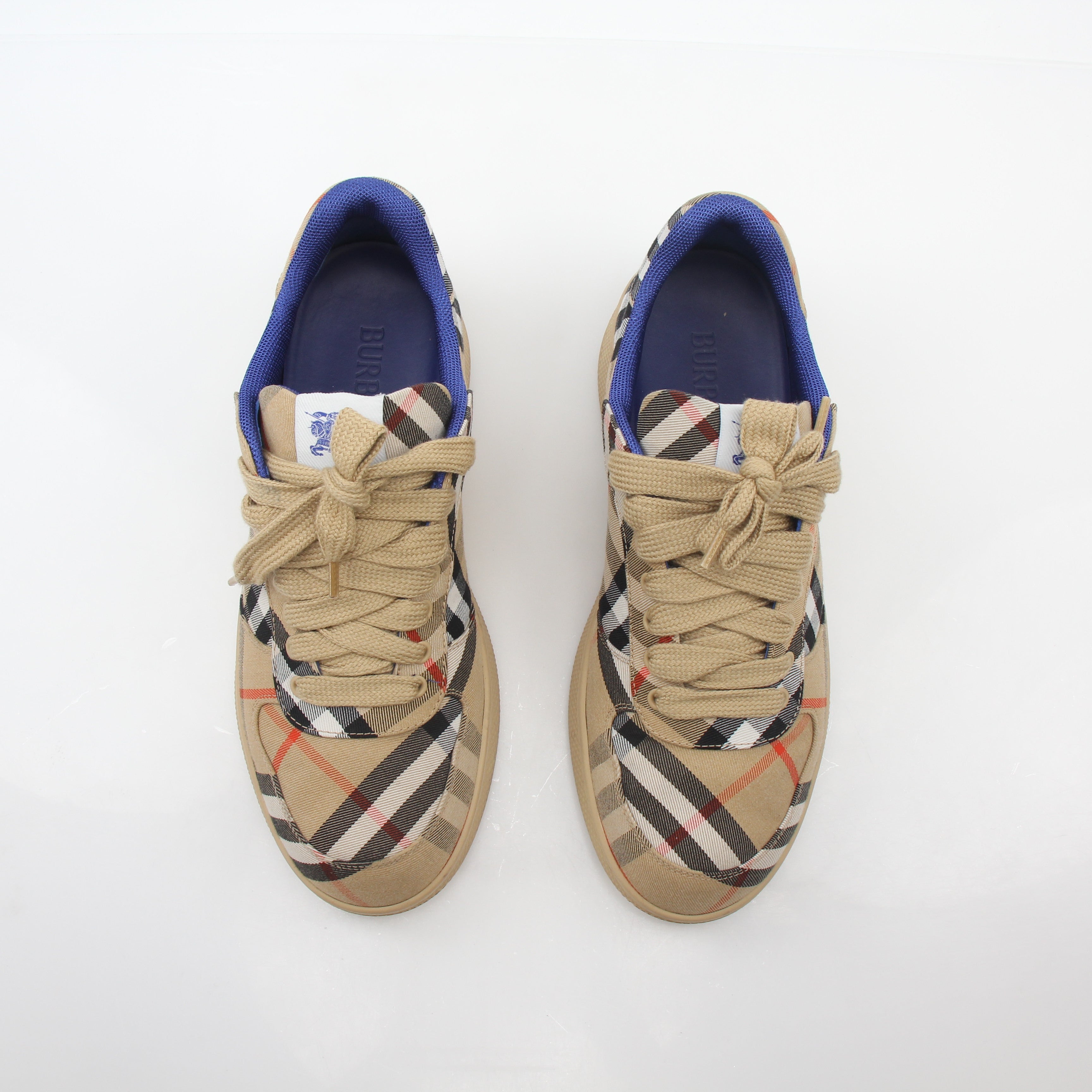 Gold & Beyond Burberry vintage check terrace low-top sneakers with beige and black plaid pattern and white rubber soles.