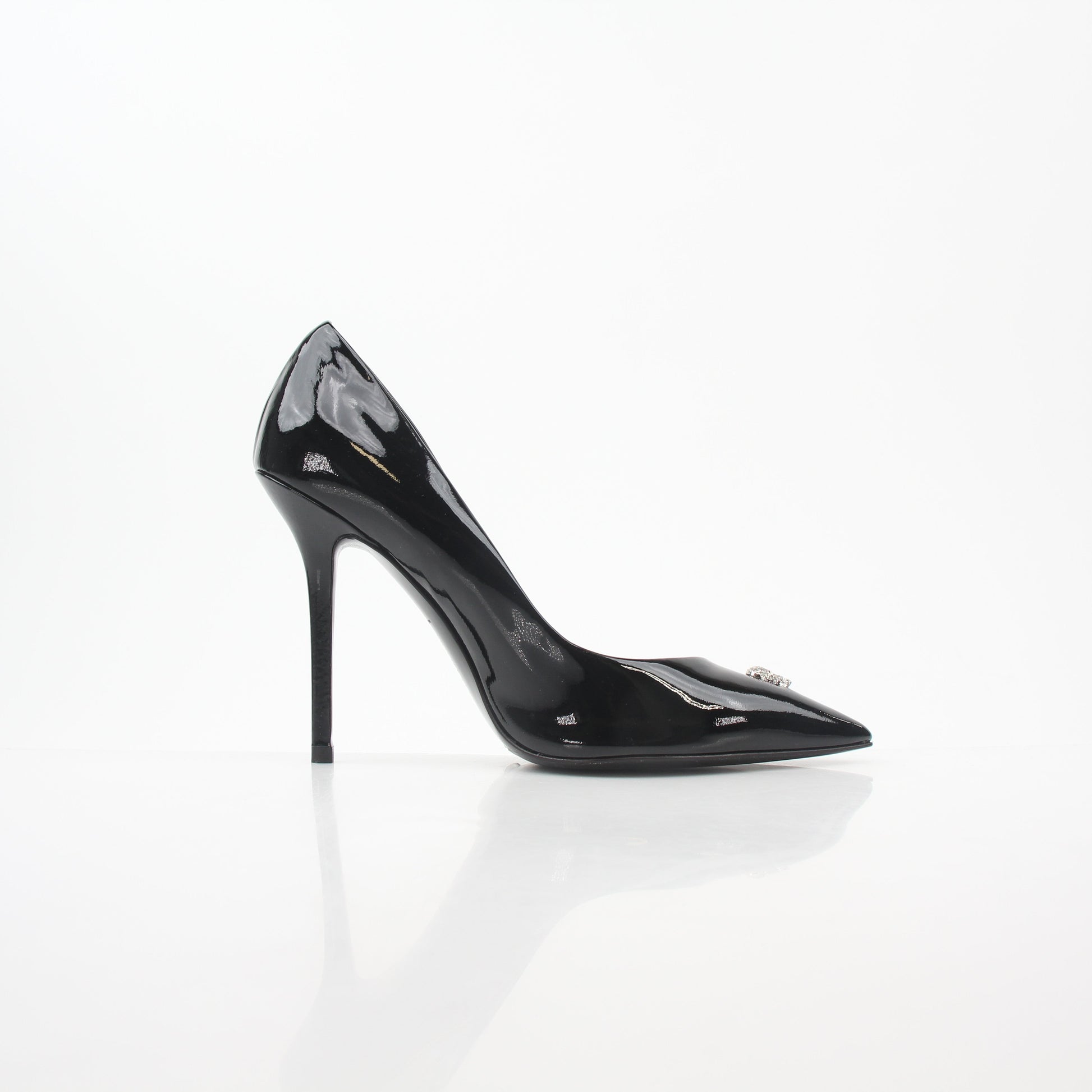 Philipp Plein black patent leather crystal skull heels with pointed toes and stiletto heels, displayed on a neutral background.