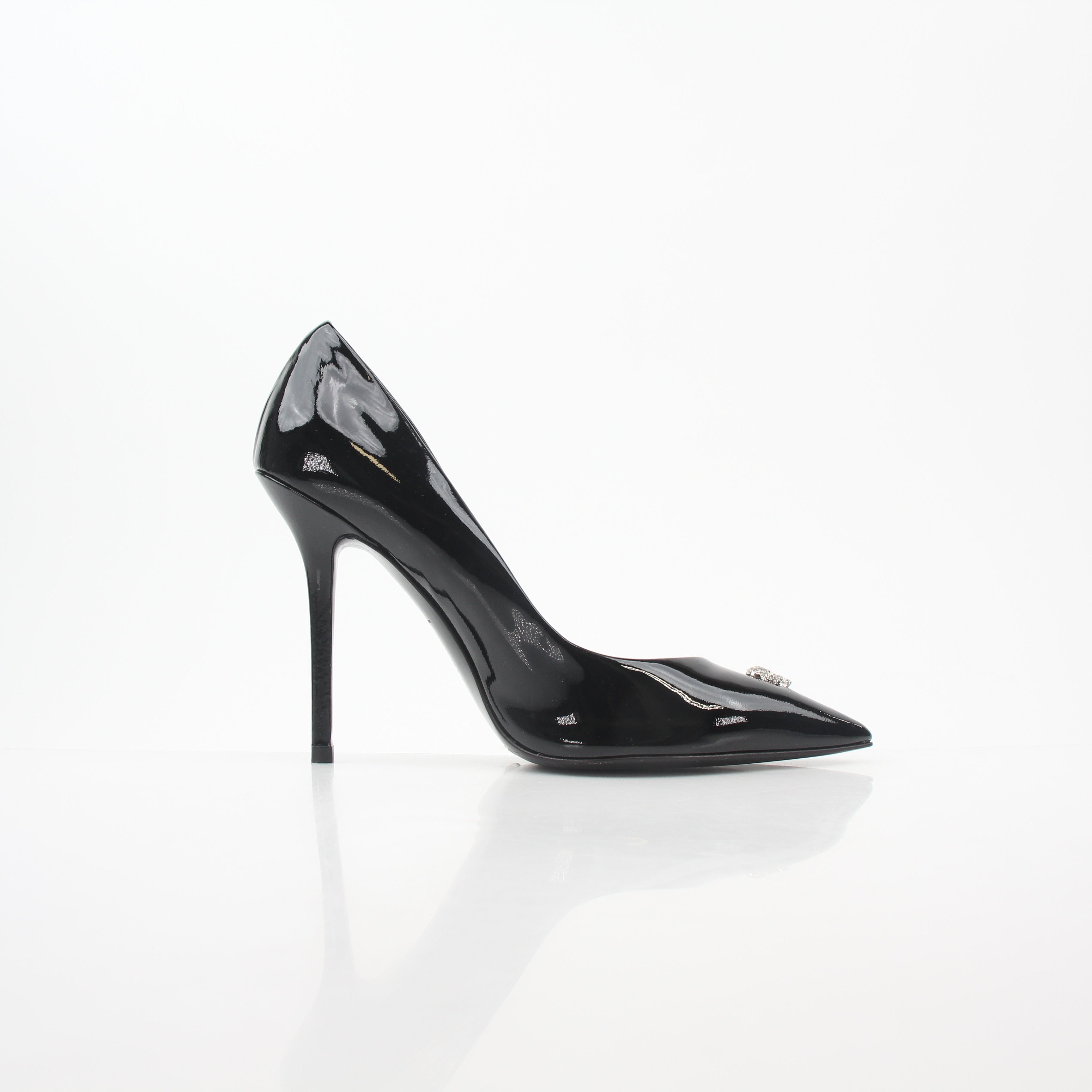 Philipp Plein black patent leather crystal skull heels with pointed toes and stiletto heels, displayed on a neutral background.