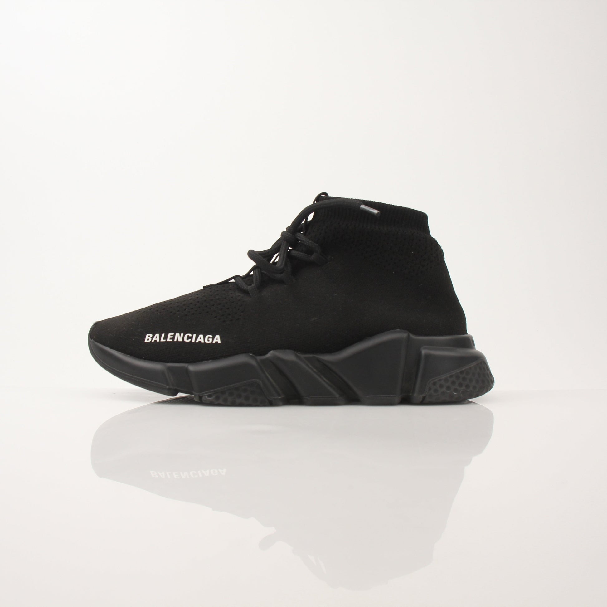 Gold & Beyond Balenciaga Speed lace-up sneakers with sleek design and bold style, showcasing modern athletic shoe features.