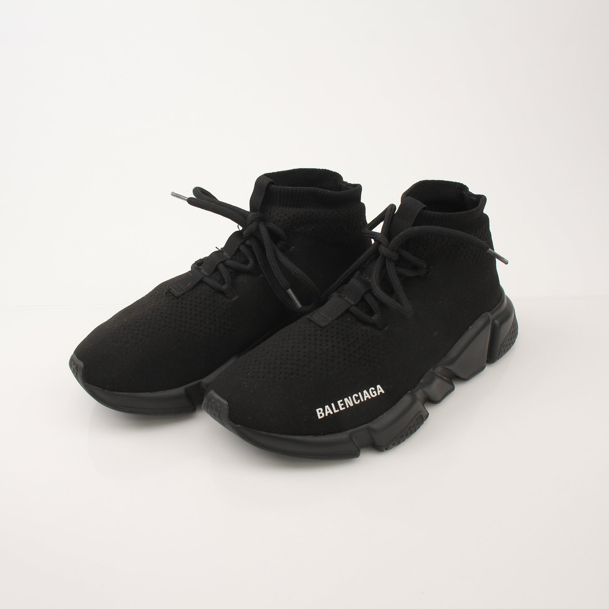 Gold & Beyond Balenciaga Speed lace-up sneakers with sleek design and white soles, positioned on a clean surface.
