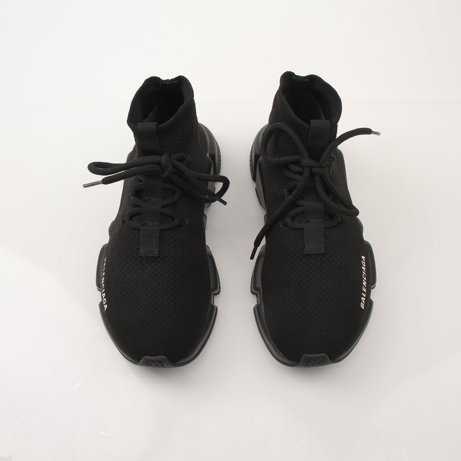 Gold & Beyond Balenciaga Speed lace-up sneakers featuring sleek design and athletic style, shown in a close-up image.