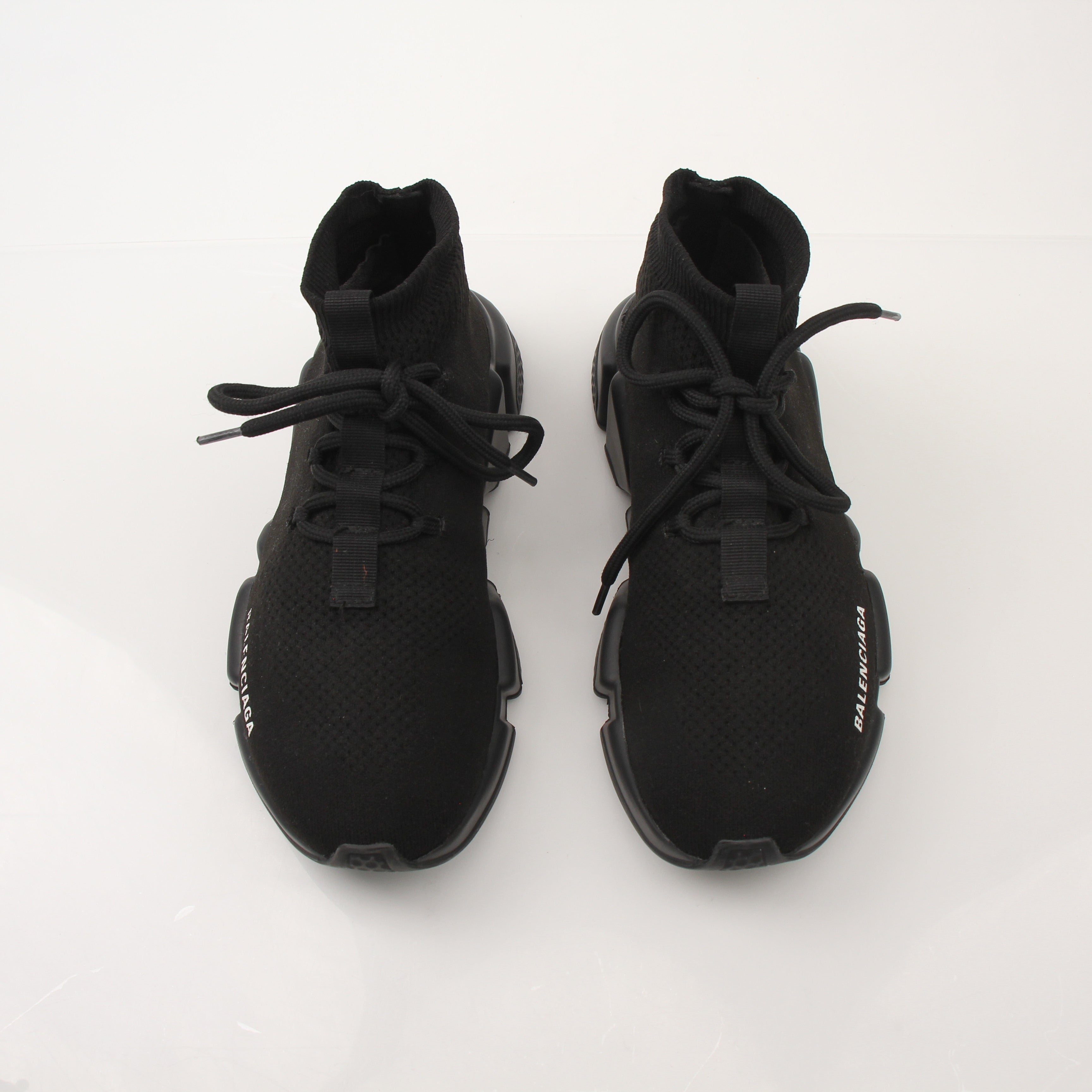 Gold & Beyond Balenciaga Speed lace-up sneakers featuring sleek design and athletic style, shown in a close-up image.
