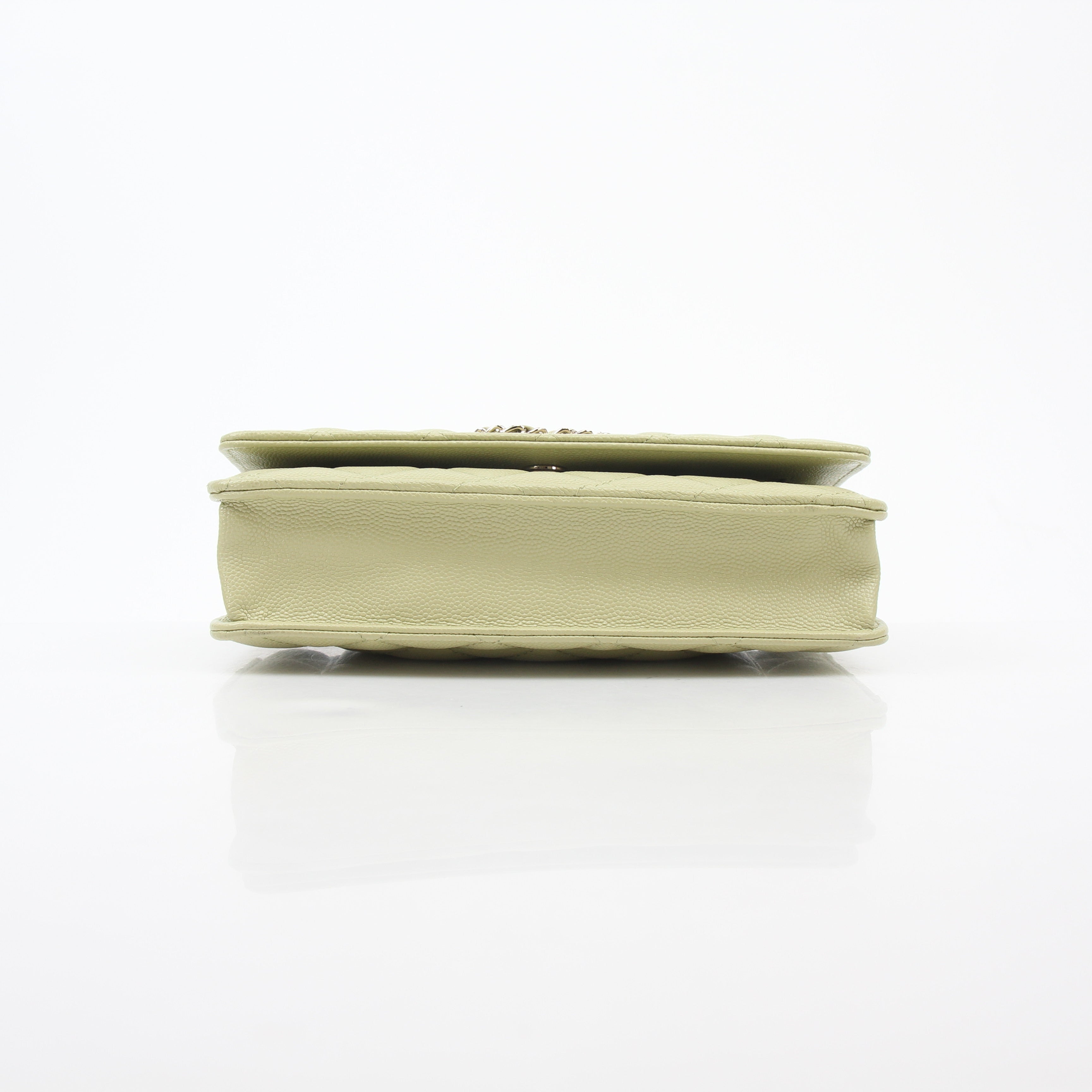 Light green Chanel caviar leather French New Wave chain CC wallet on chain handbag with gold hardware and chain strap.