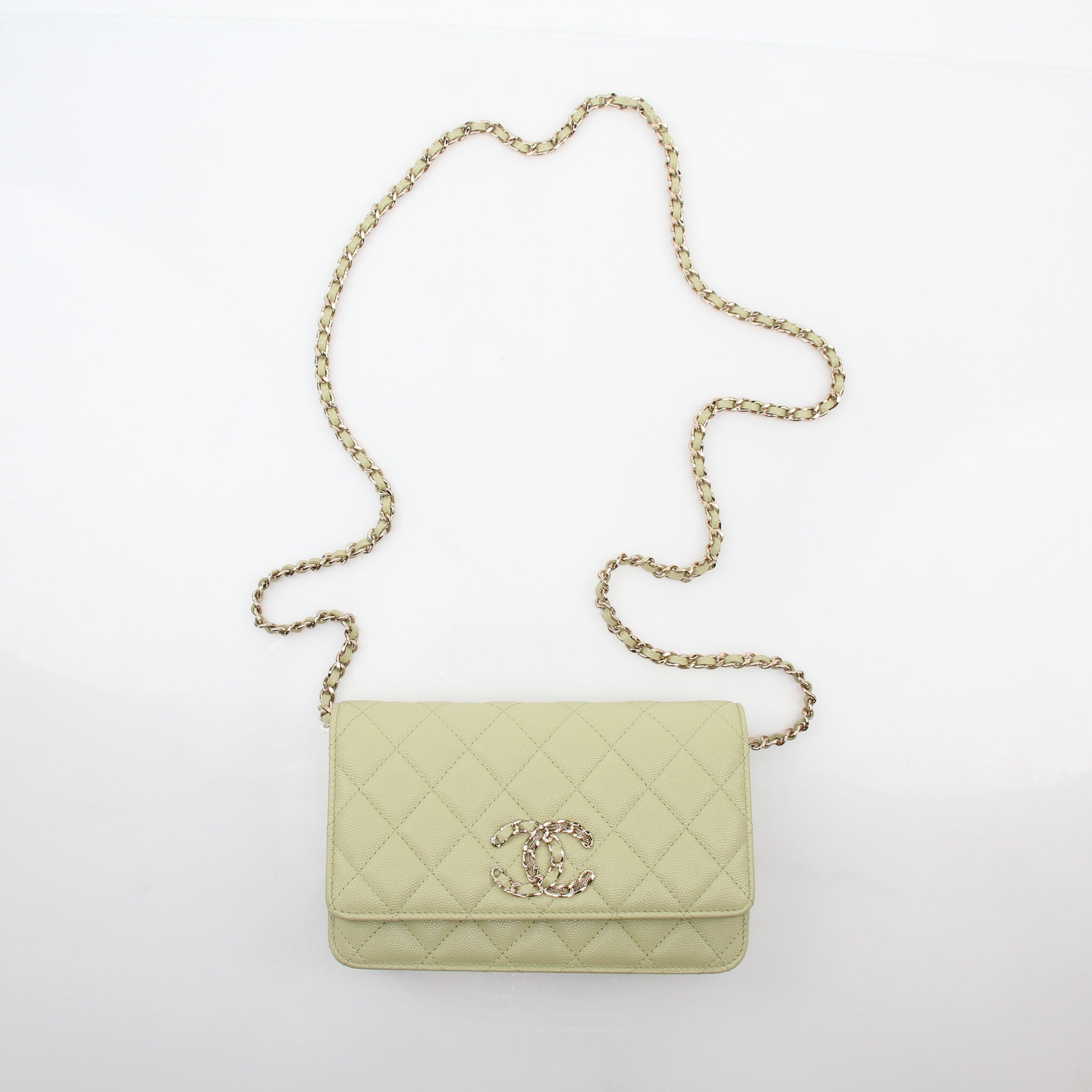 Light green Chanel Caviar French New Wave Chain CC wallet on chain handbag with gold hardware and chain strap.