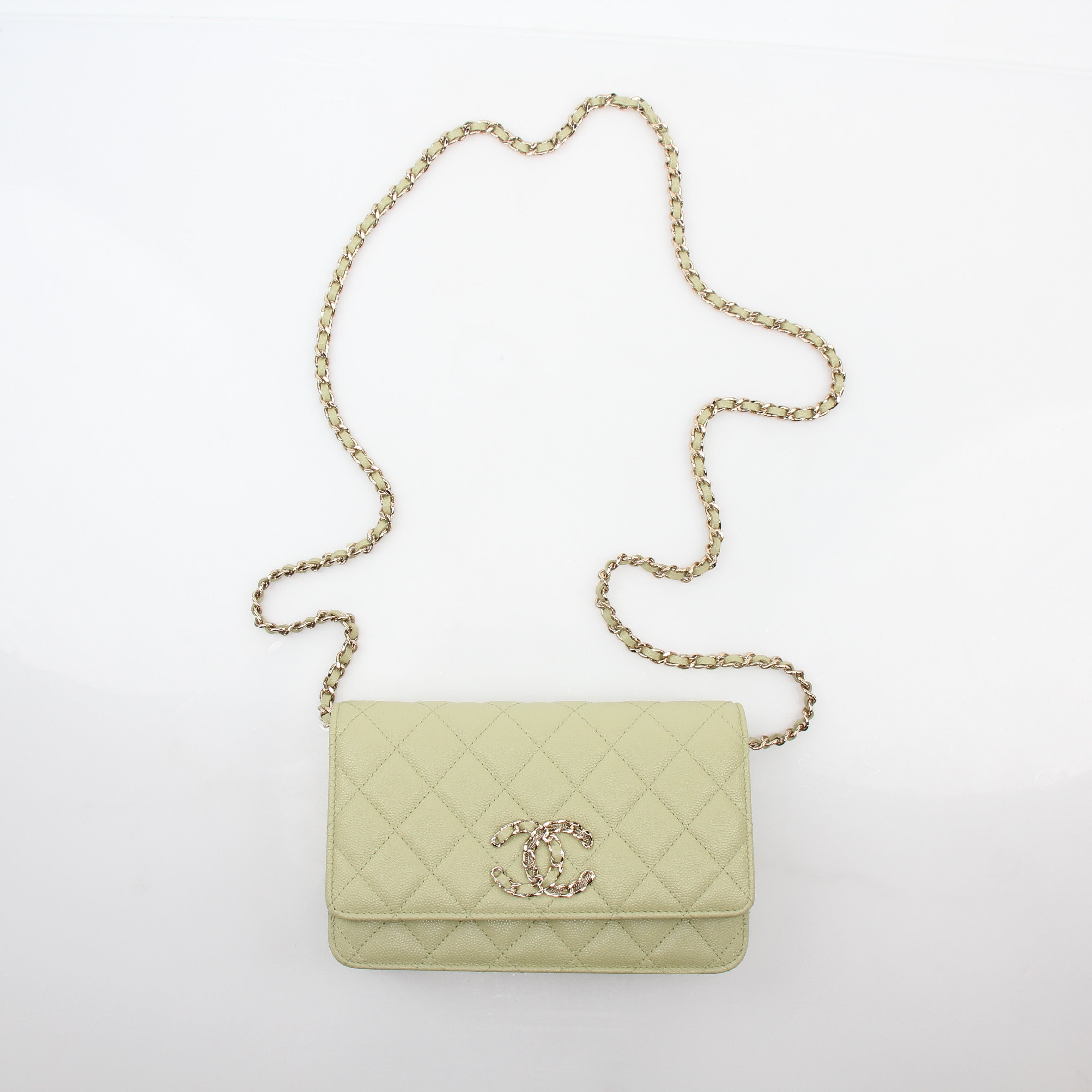 Light green Chanel Caviar French New Wave Chain CC wallet on chain handbag with gold hardware and chain strap.