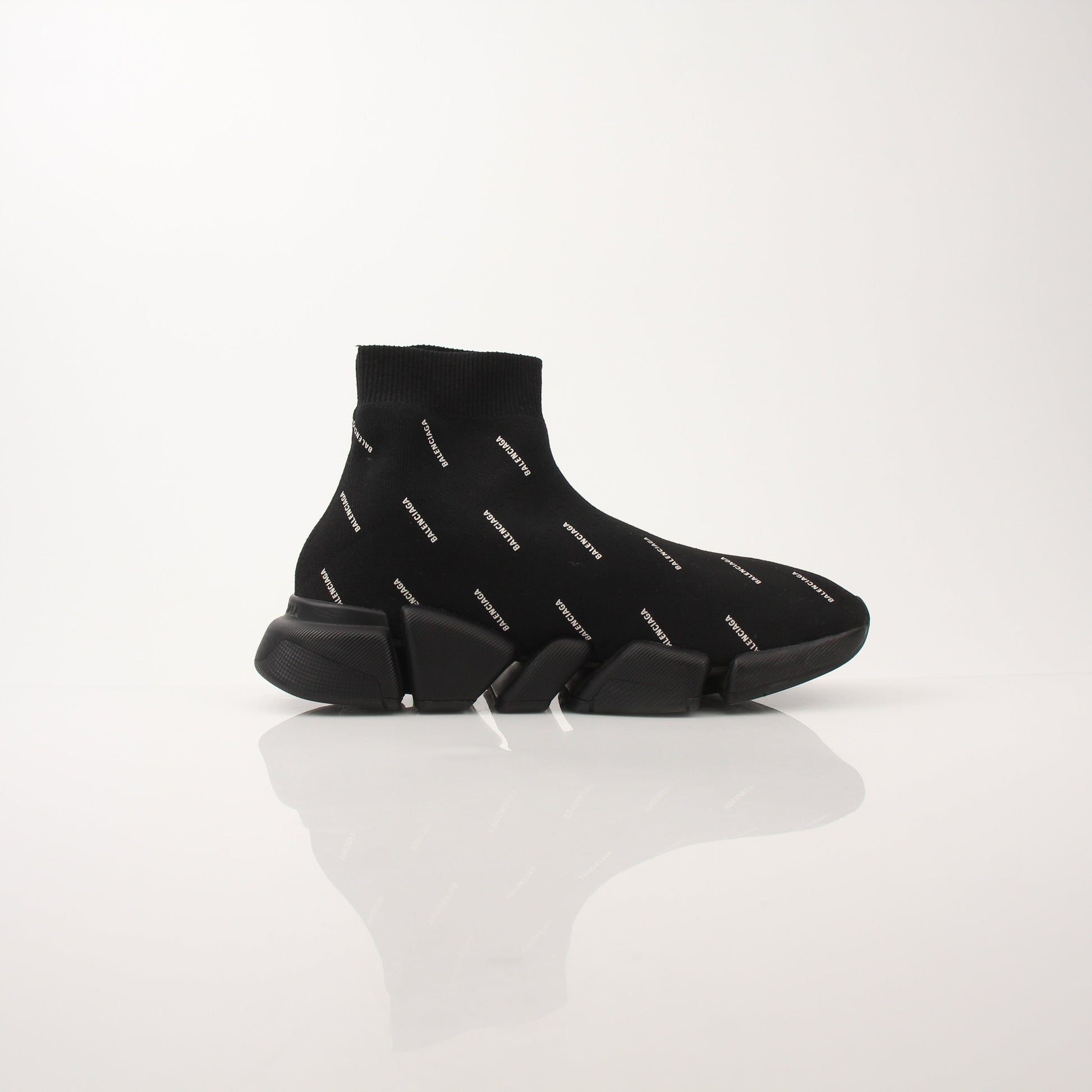 Gold & Beyond women's Balenciaga All Over Logo Speed 2.0 sneakers showing the design and logo pattern on the shoes.