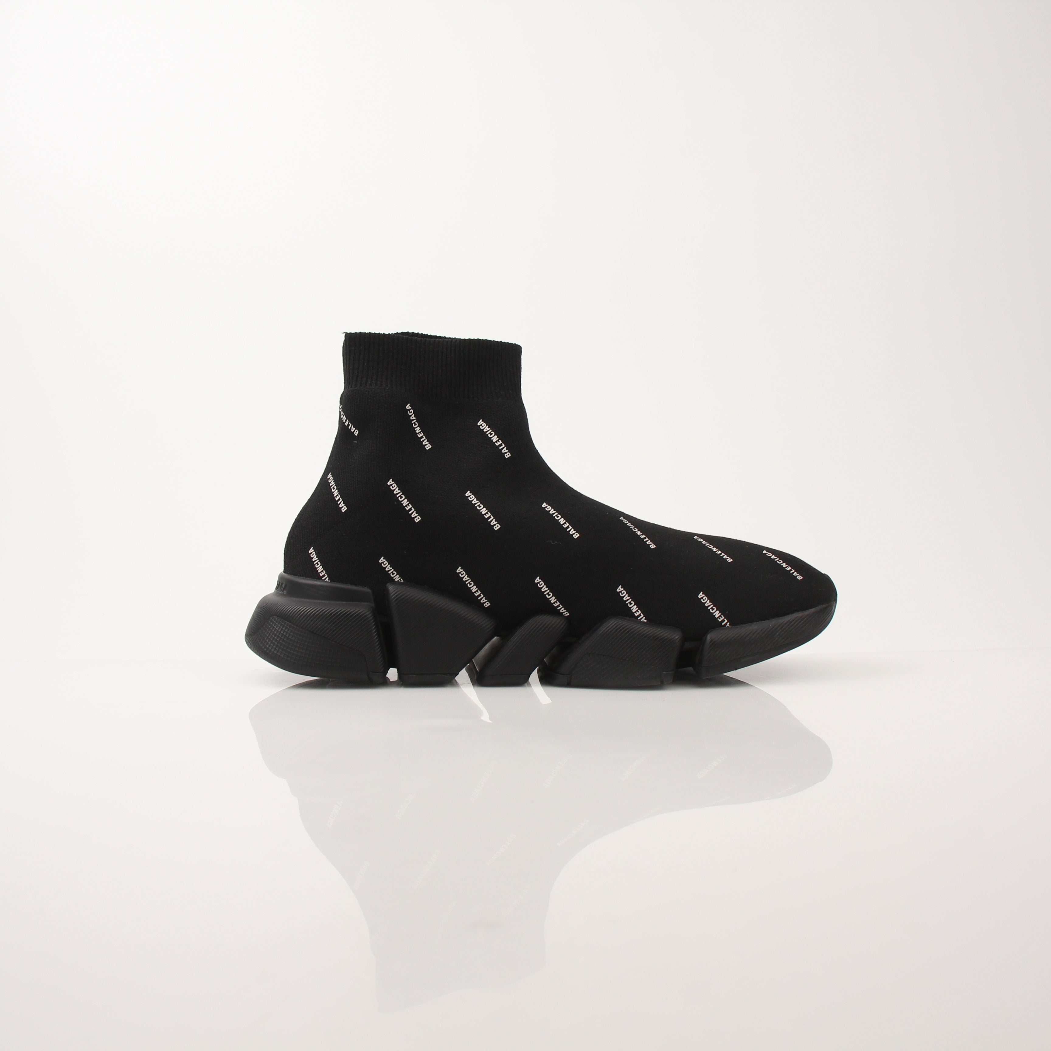 Gold & Beyond women's Balenciaga All Over Logo Speed 2.0 sneakers showing the design and logo pattern on the shoes.