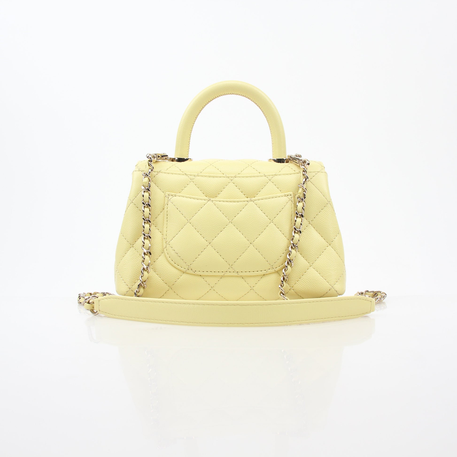 Yellow Chanel Mini Coco Handle Flap Bag, gold hardware, leather handbag with top handle and signature quilted design.