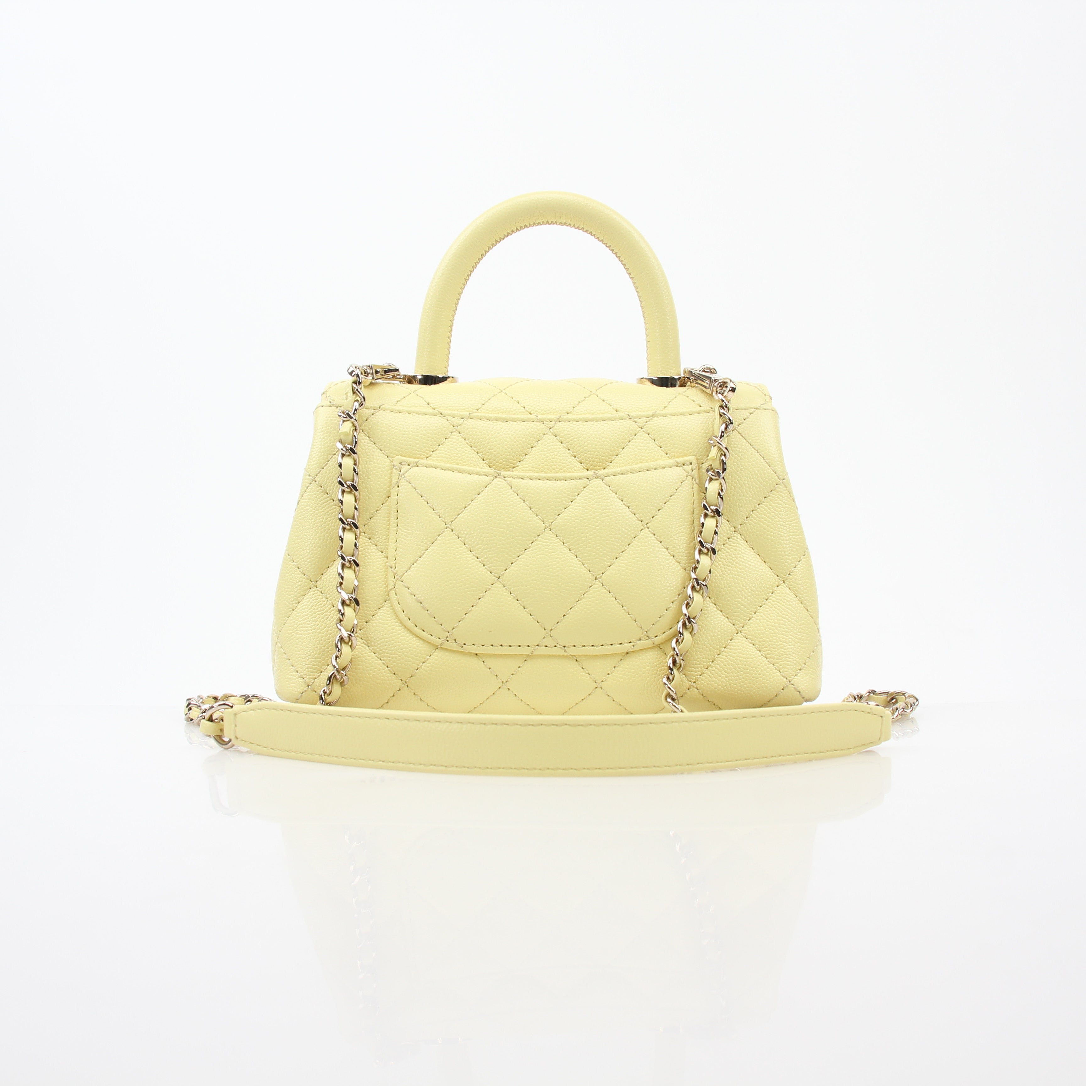Yellow Chanel Mini Coco Handle Flap Bag, gold hardware, leather handbag with top handle and signature quilted design.