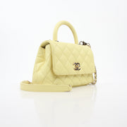 Yellow Chanel Mini Coco Handle Flap Bag, elegant handbag with gold accents, from Gold & Beyond.