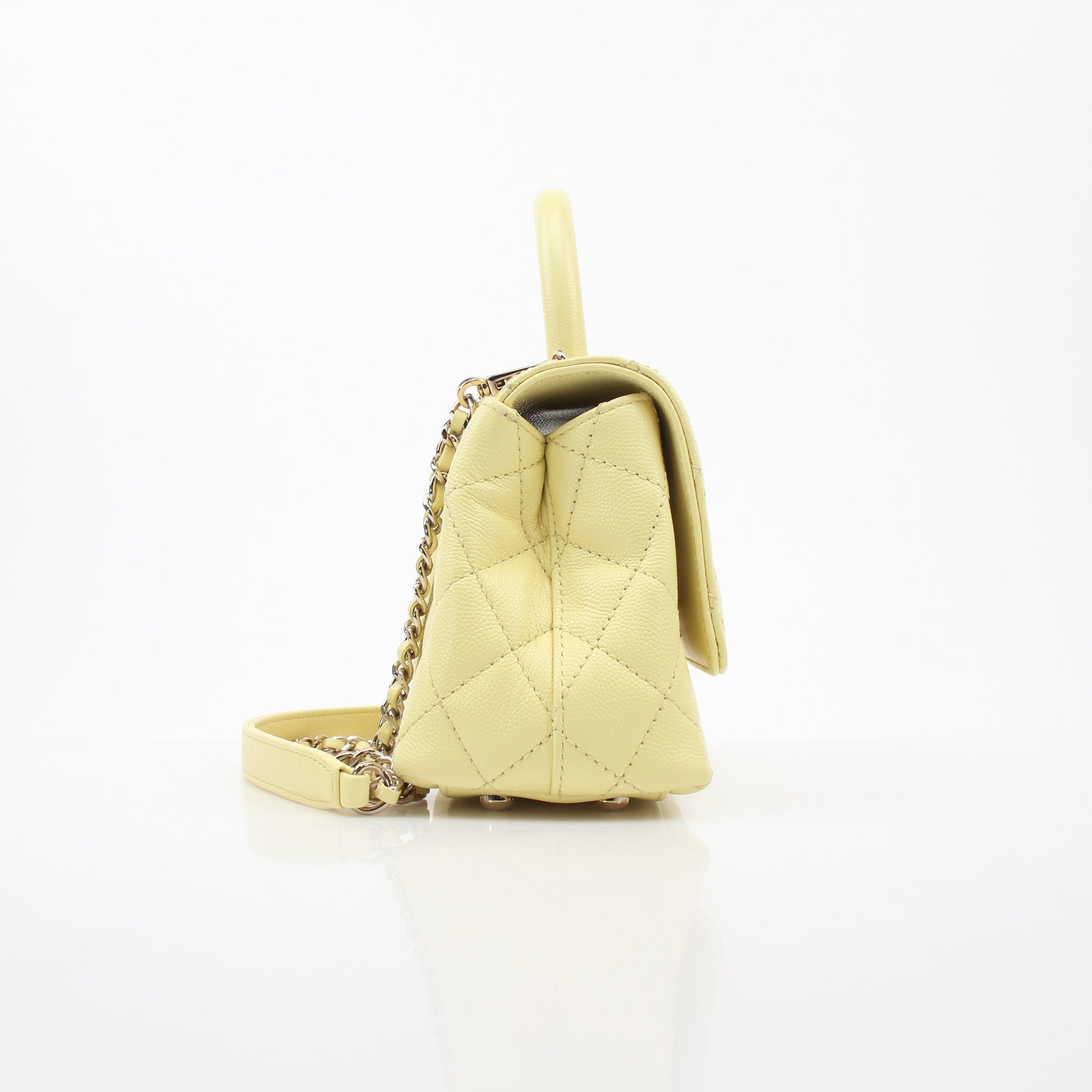 Yellow Chanel Mini Coco Handle Flap Bag, gold hardware, with quilted leather and signature Chanel design details.