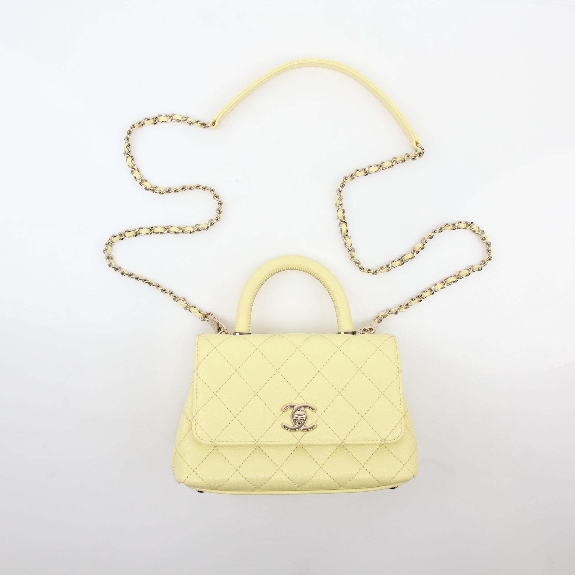 Yellow Chanel Mini Coco Handle Flap Bag handbag with gold hardware and classic quilted design.